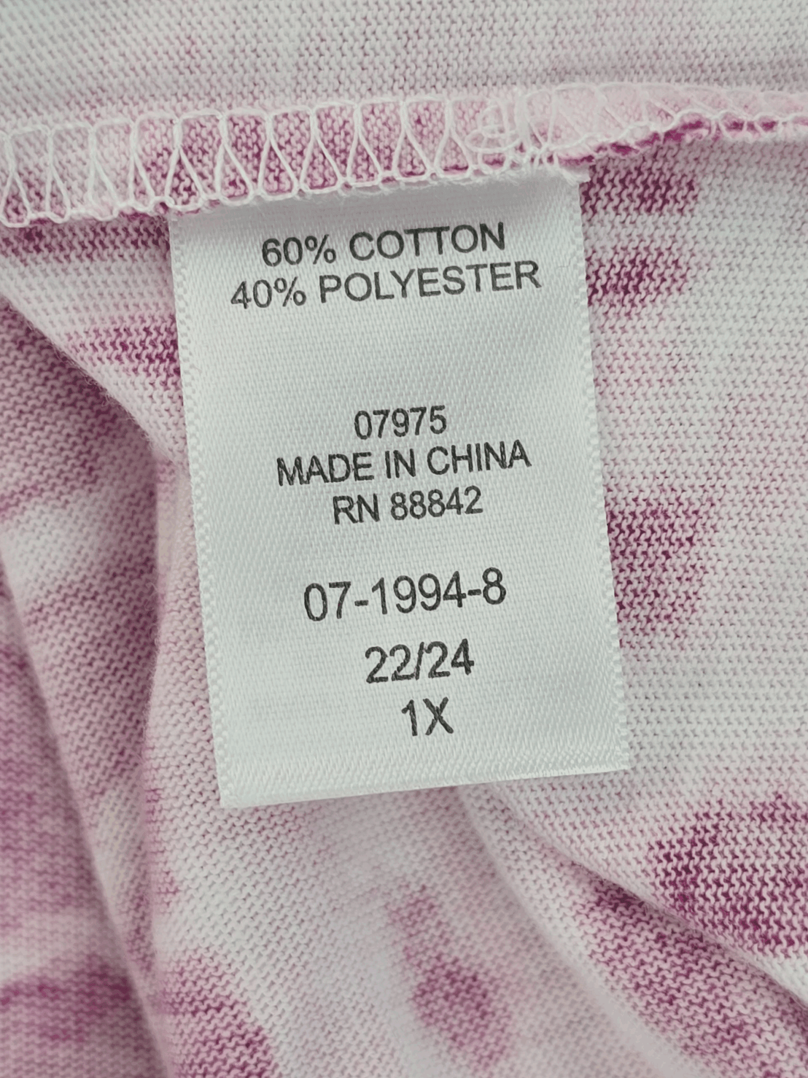 Clothing label showing fabric content and size information.