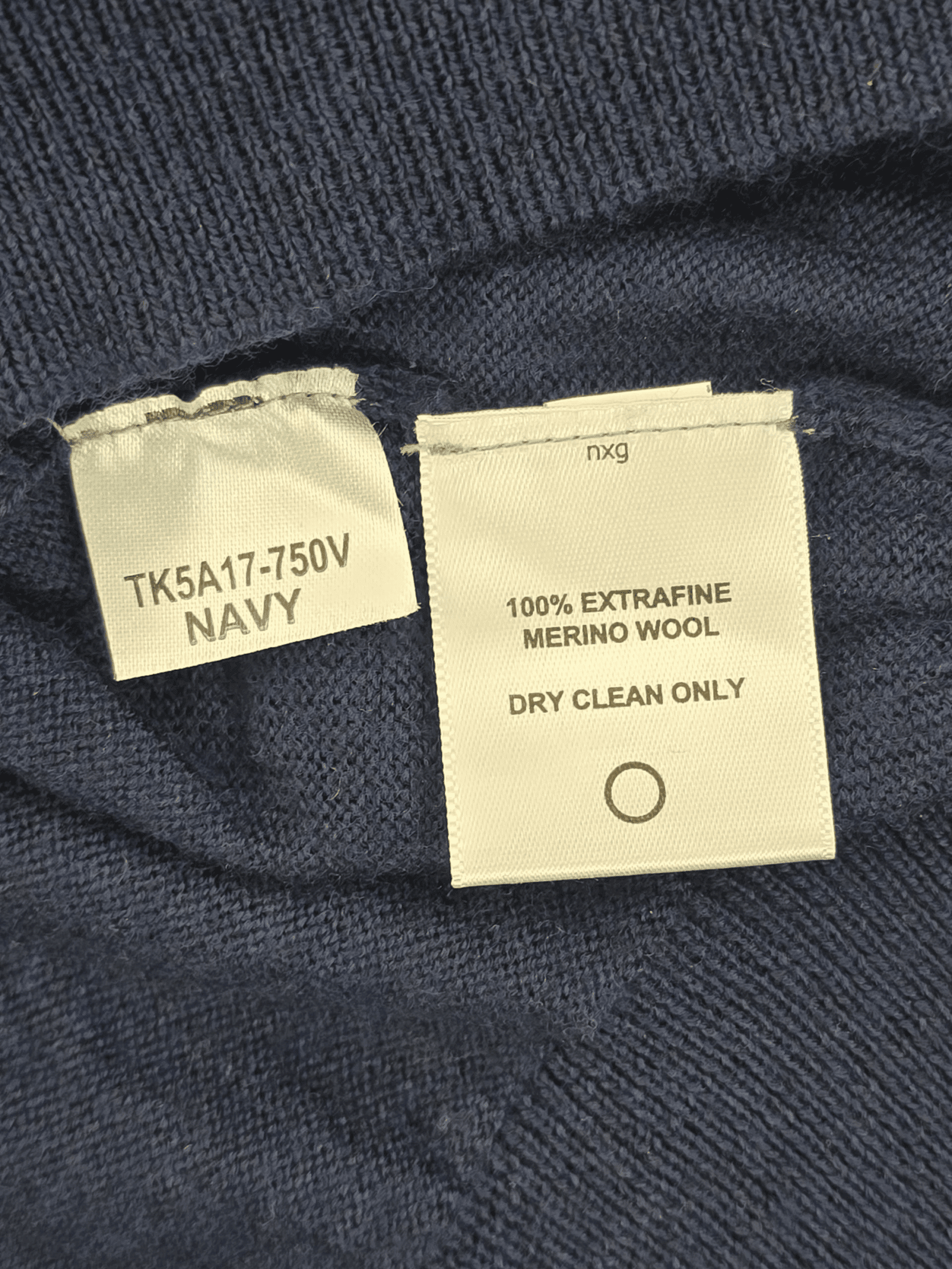 Close-up of clothing labels showing fabric composition and care instructions.