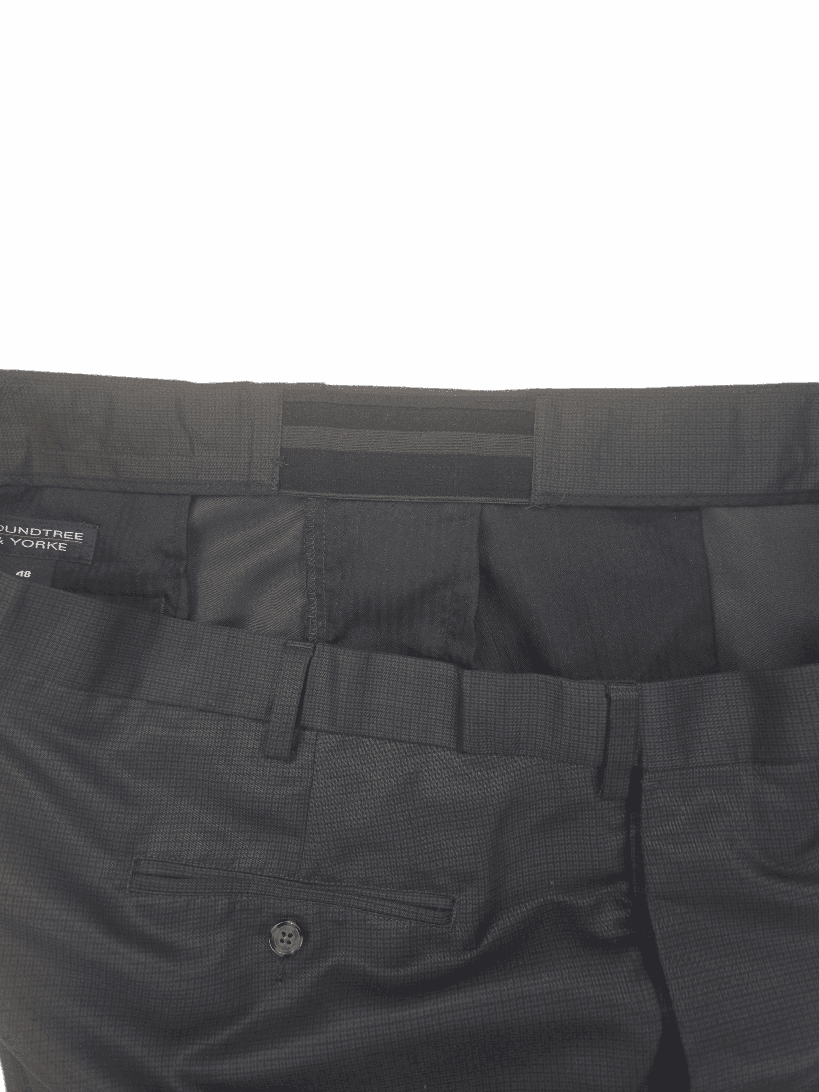 Close-up of black pants with detailed waistband and pockets.