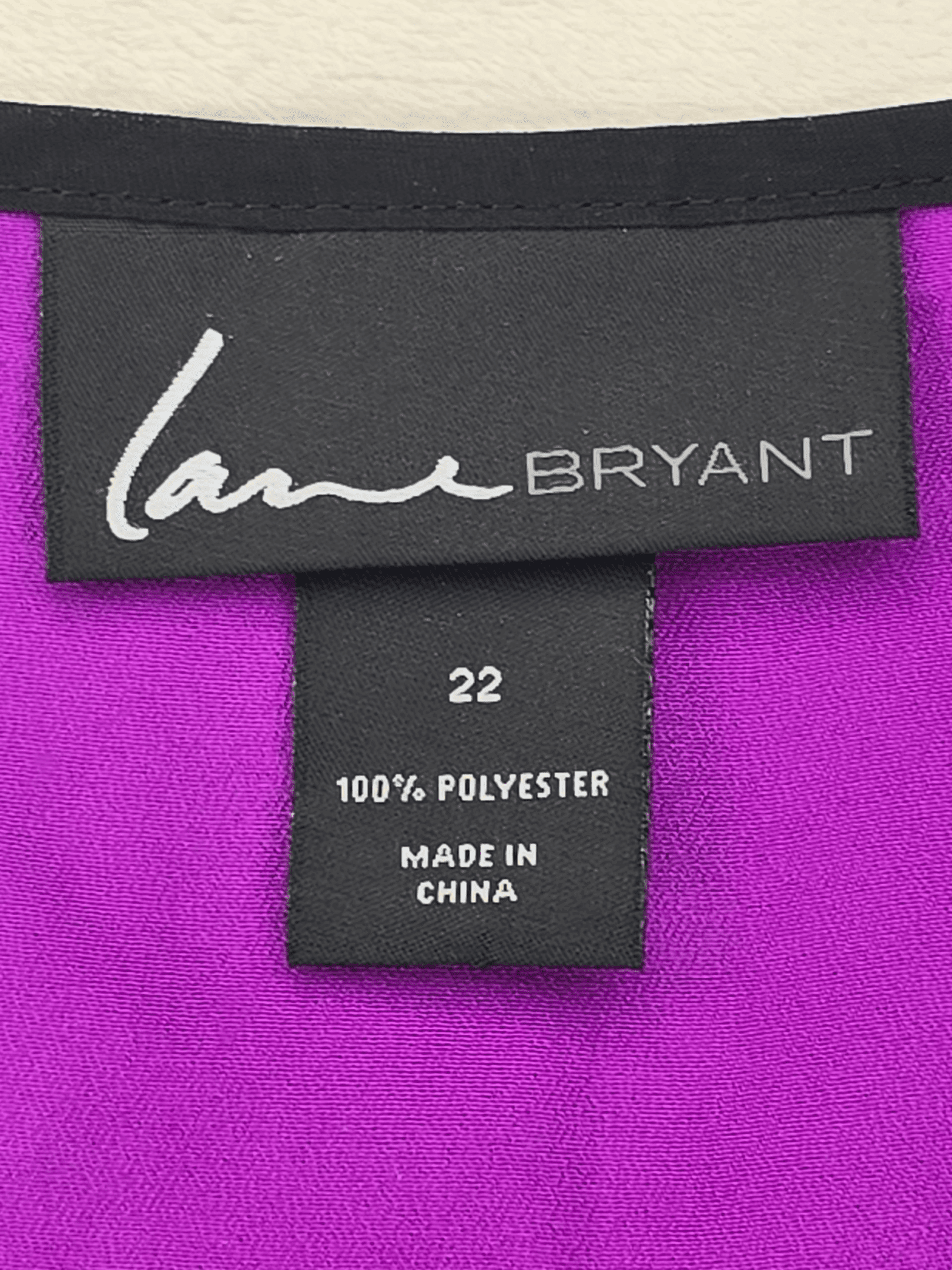 Close-up of a clothing label showing brand and fabric details.