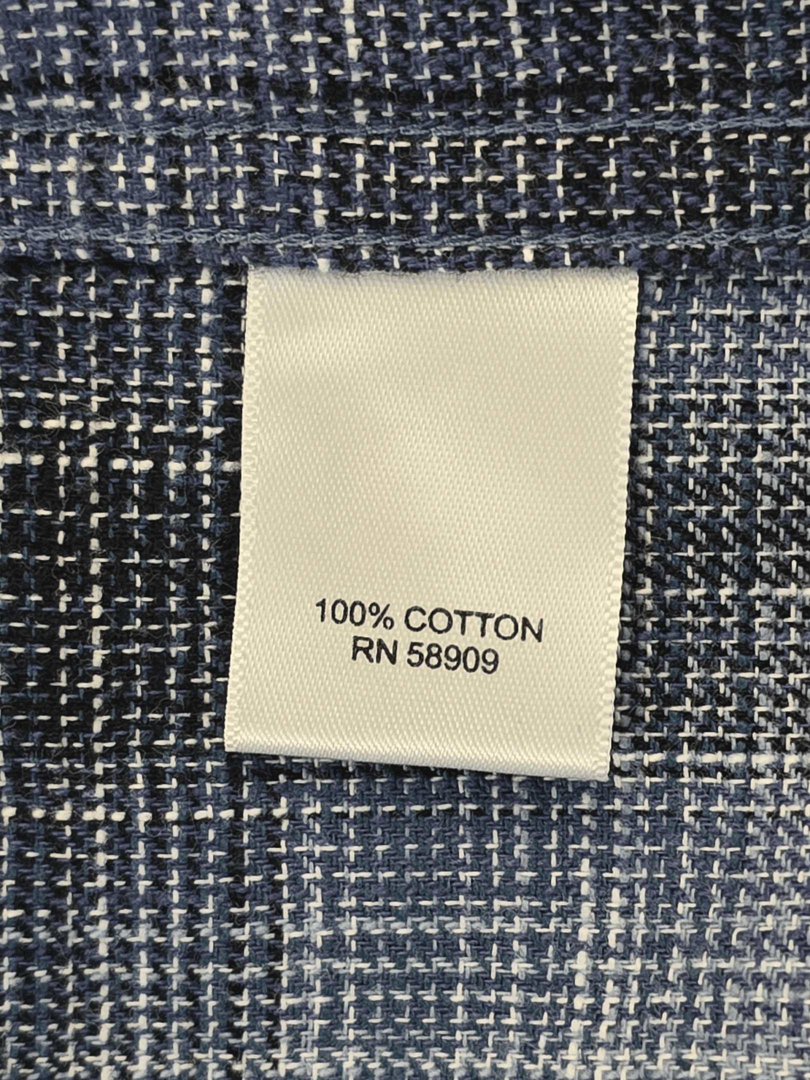 Clothing tag indicating 100% cotton material.