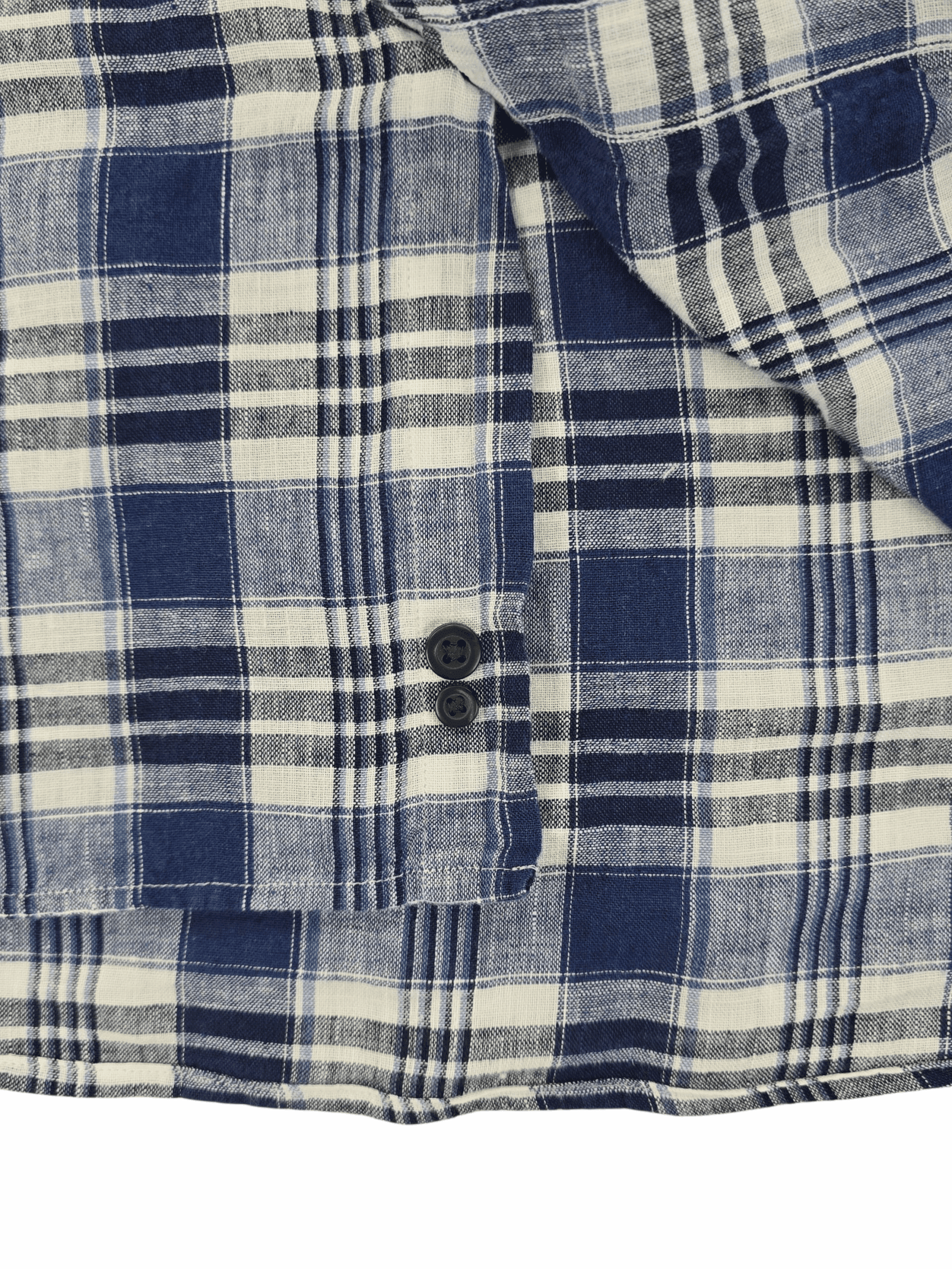 Close-up of a blue and white plaid shirt cuff with buttons.