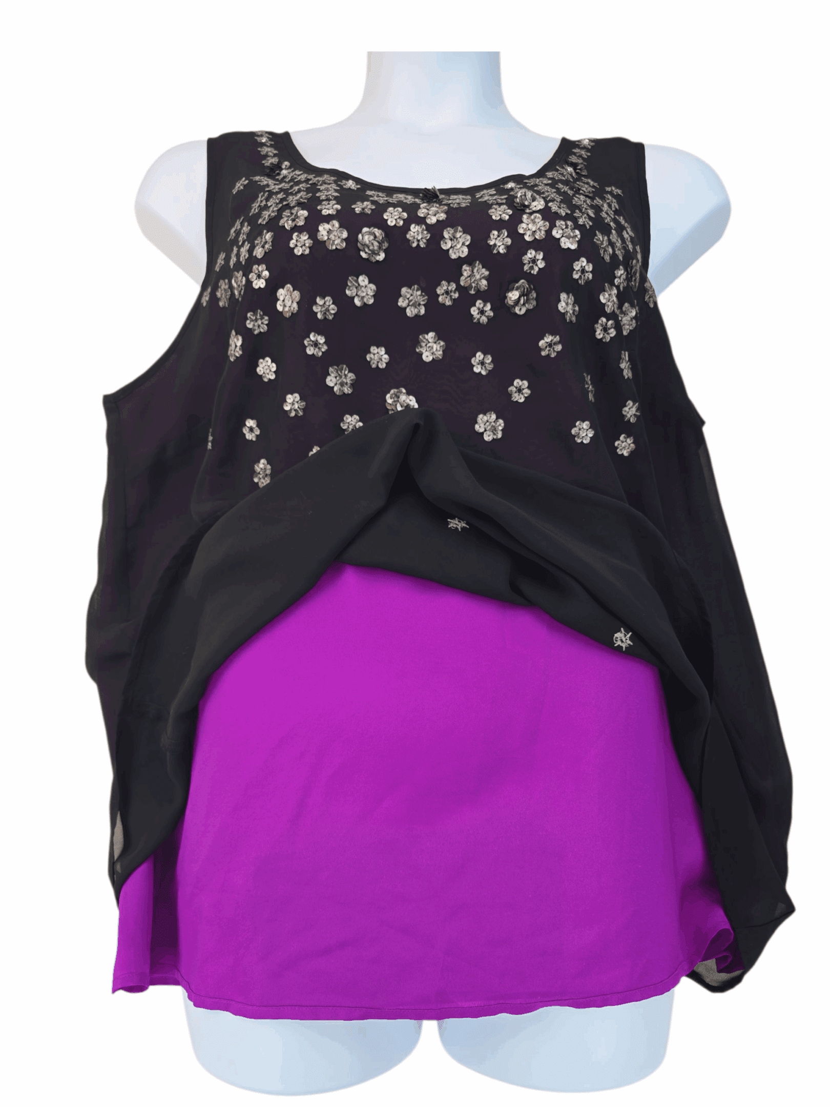 Black sleeveless top with floral embellishments paired with a bright purple skirt.