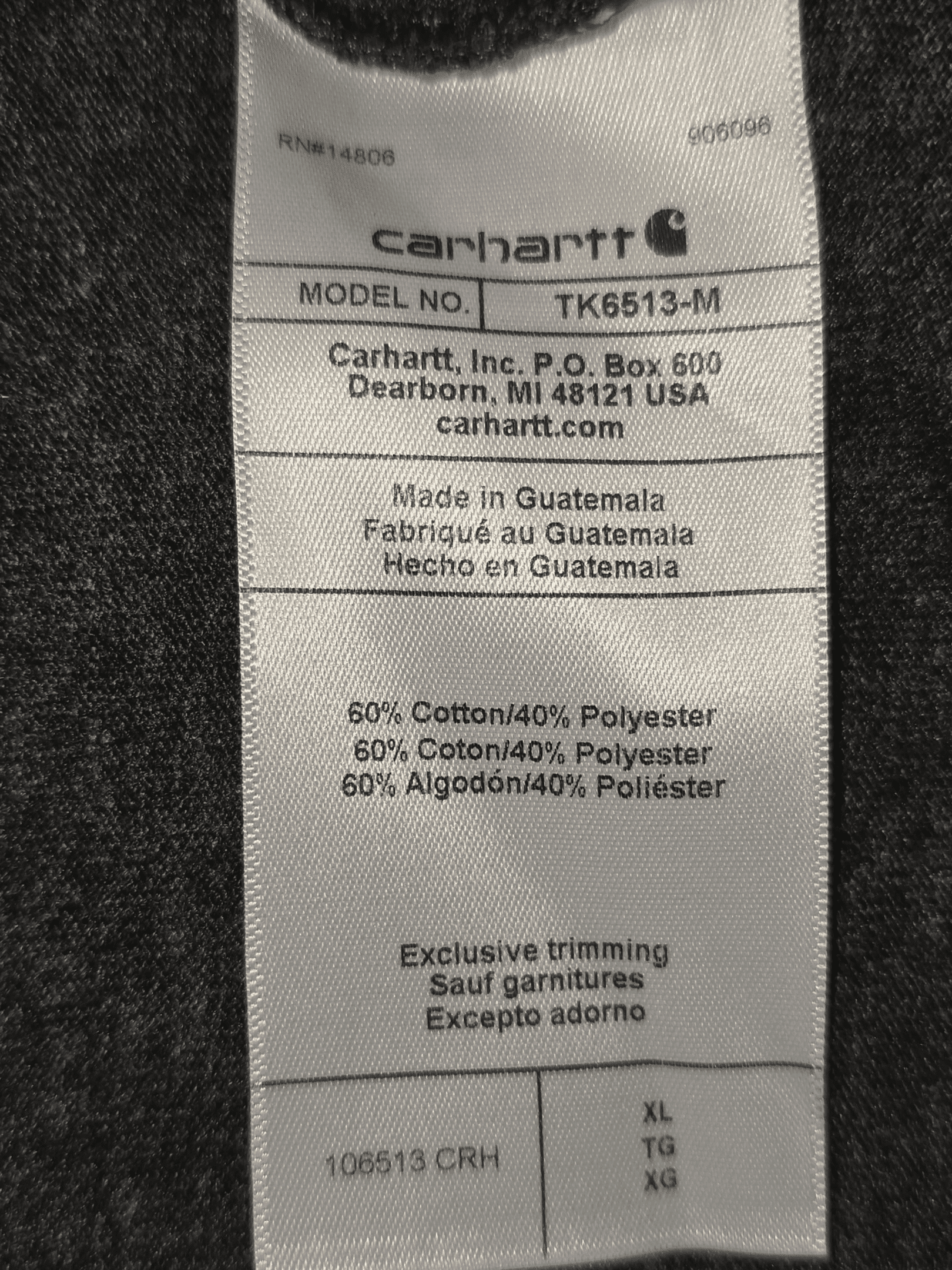 Carhartt clothing label detailing fabric and care instructions.