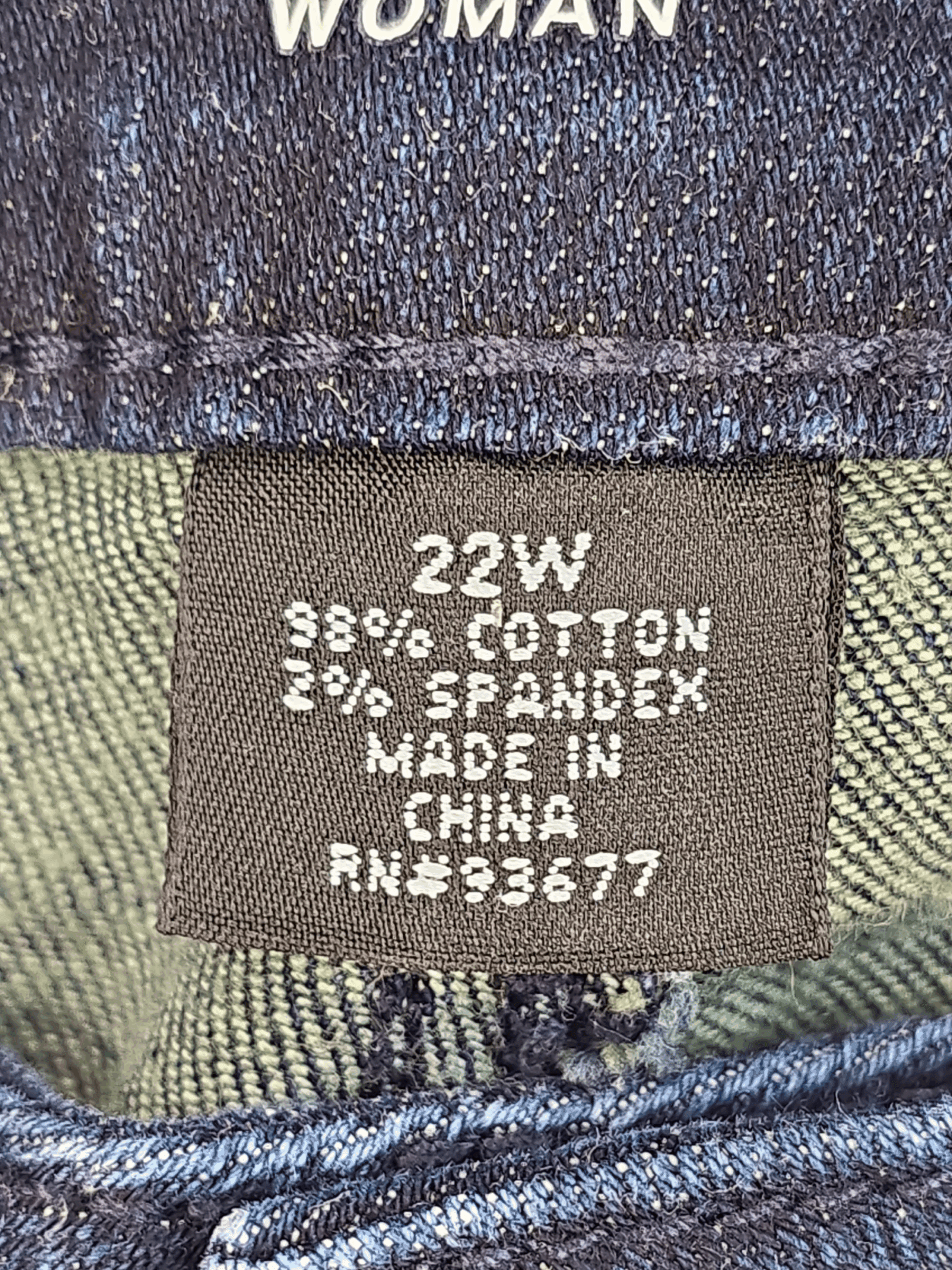 Clothing label showing size 22W and fabric details.