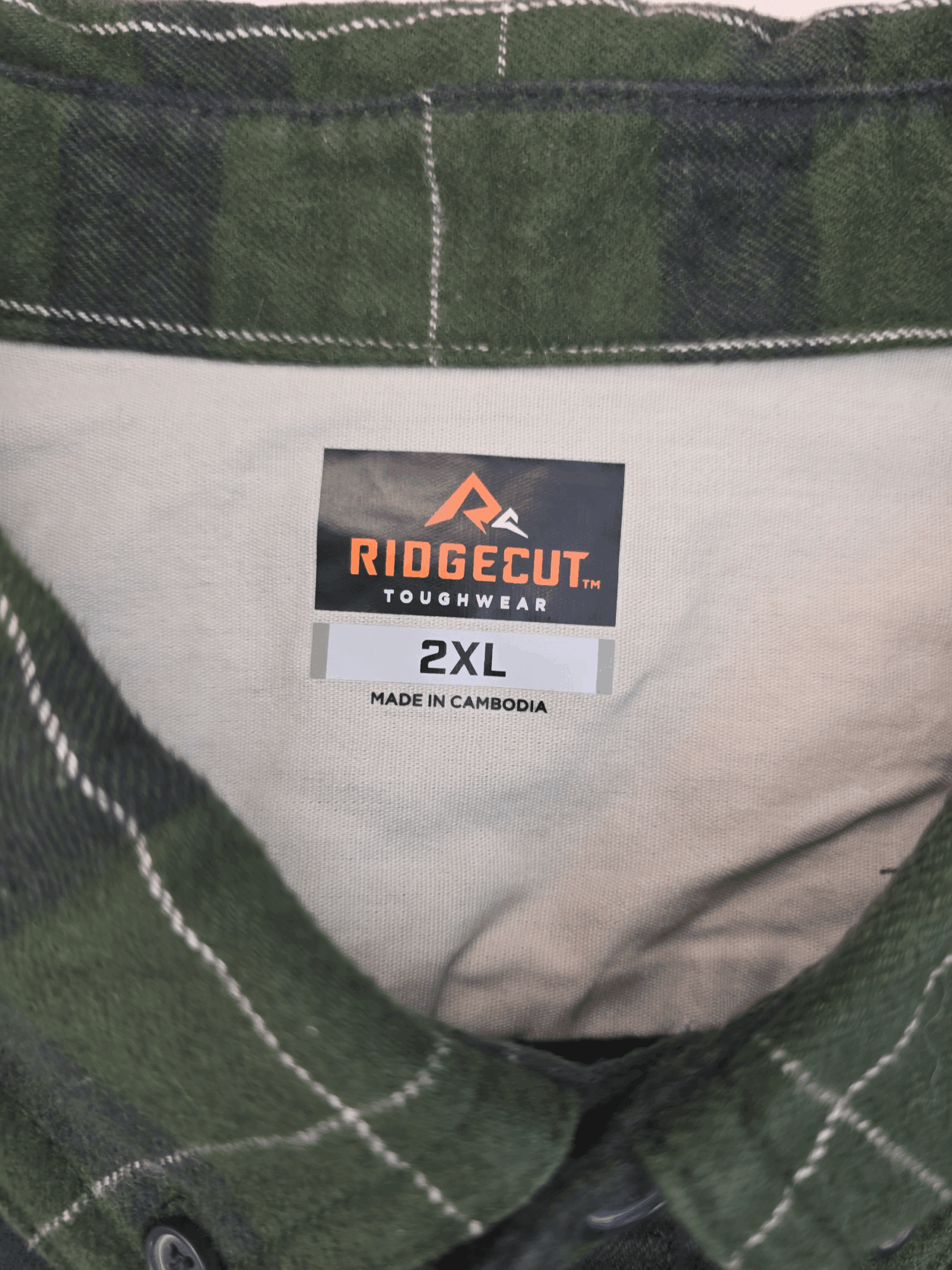 Clothing label showing Ridgecut brand and size 2XL.