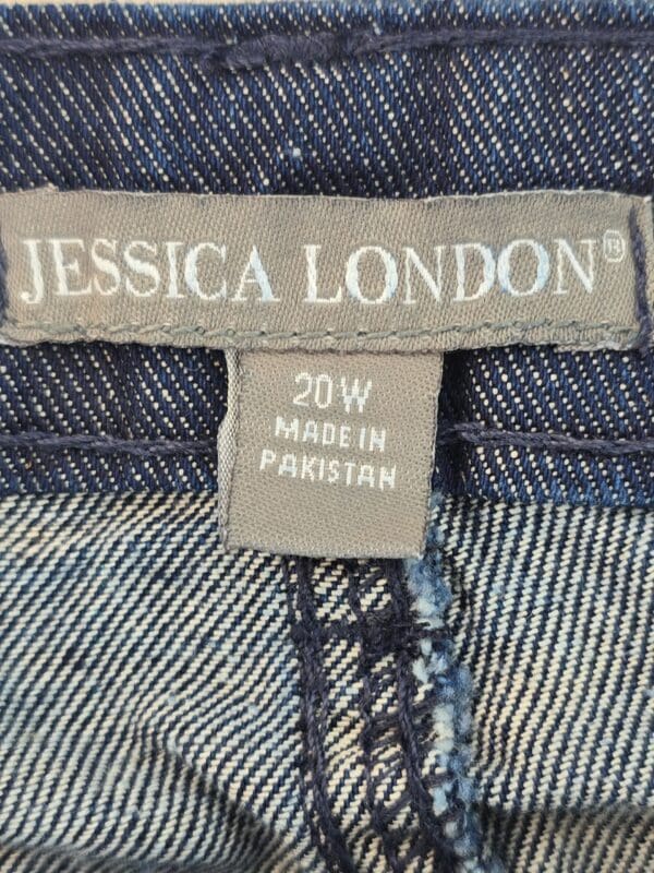 Close-up of a clothing label on denim jeans.