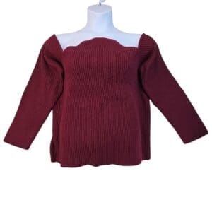 Elegant maroon off-shoulder sweater with long sleeves and a scalloped neckline.