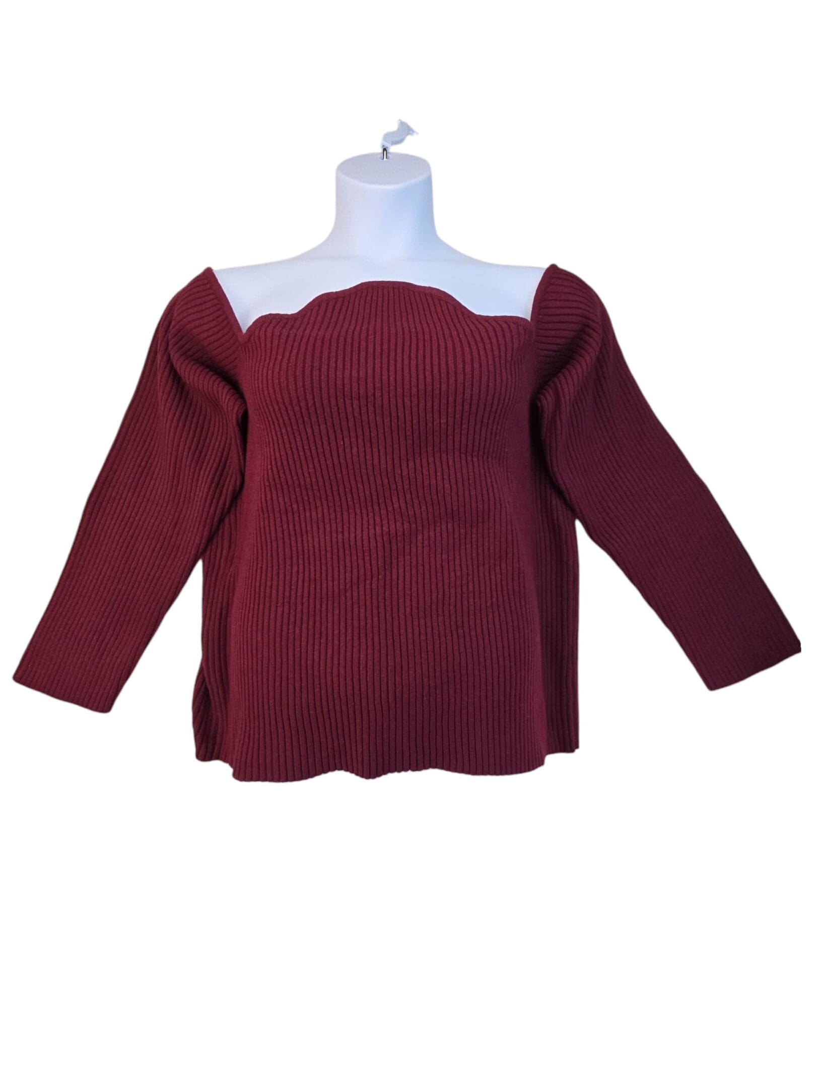 Elegant maroon off-shoulder sweater with long sleeves and a scalloped neckline.