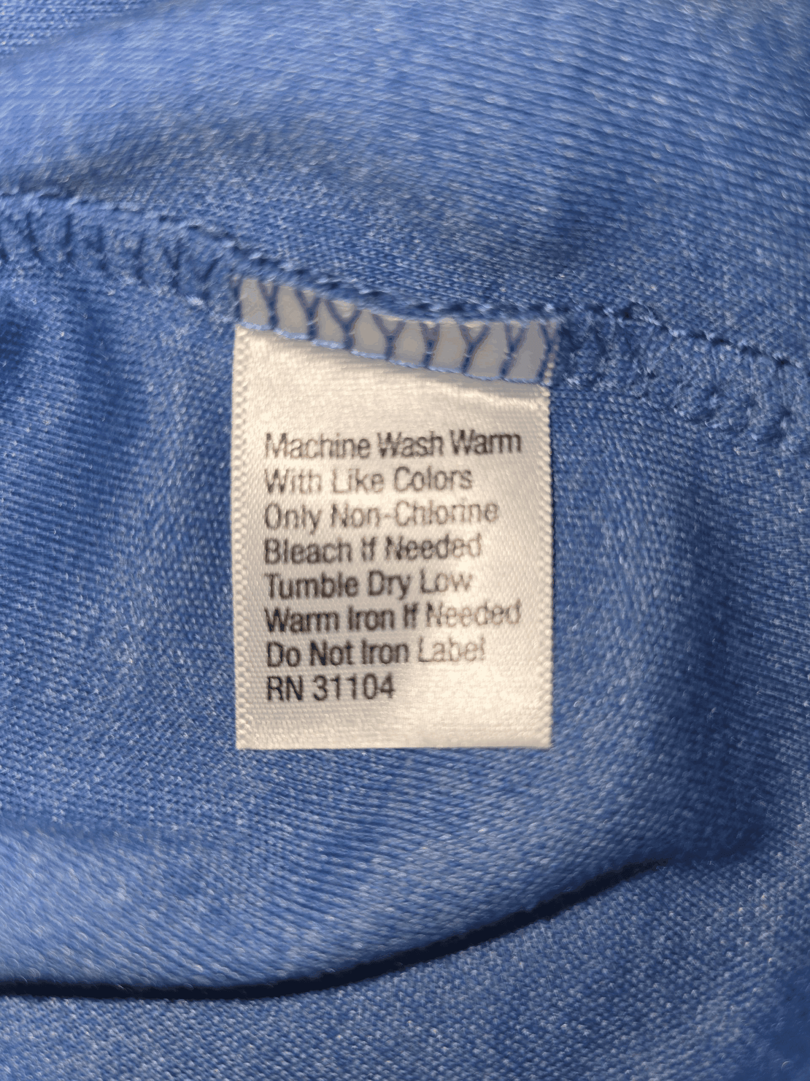 Close-up of material content and garment care tag on Saddlebred men’s size XXL blue mock neck pullover