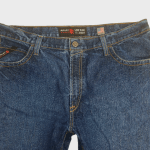 Close-up of front of Ariat men’s size 40x32 M4 FR low-rise bootcut jeans showing waistband, button, and pocket detail