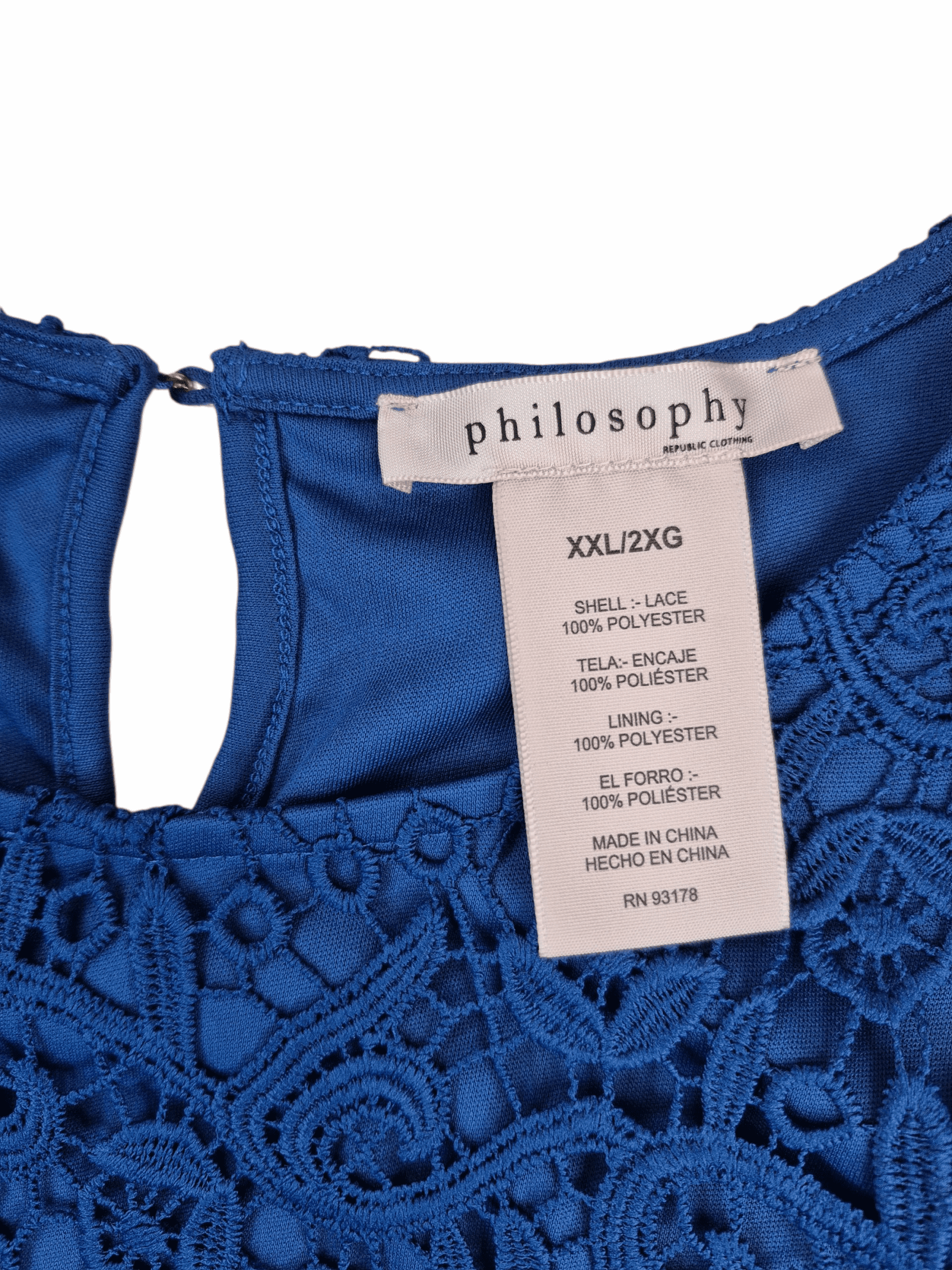 Close-up of Philosophy Republic Clothing brand and 2X size tag on blue lace overlay top