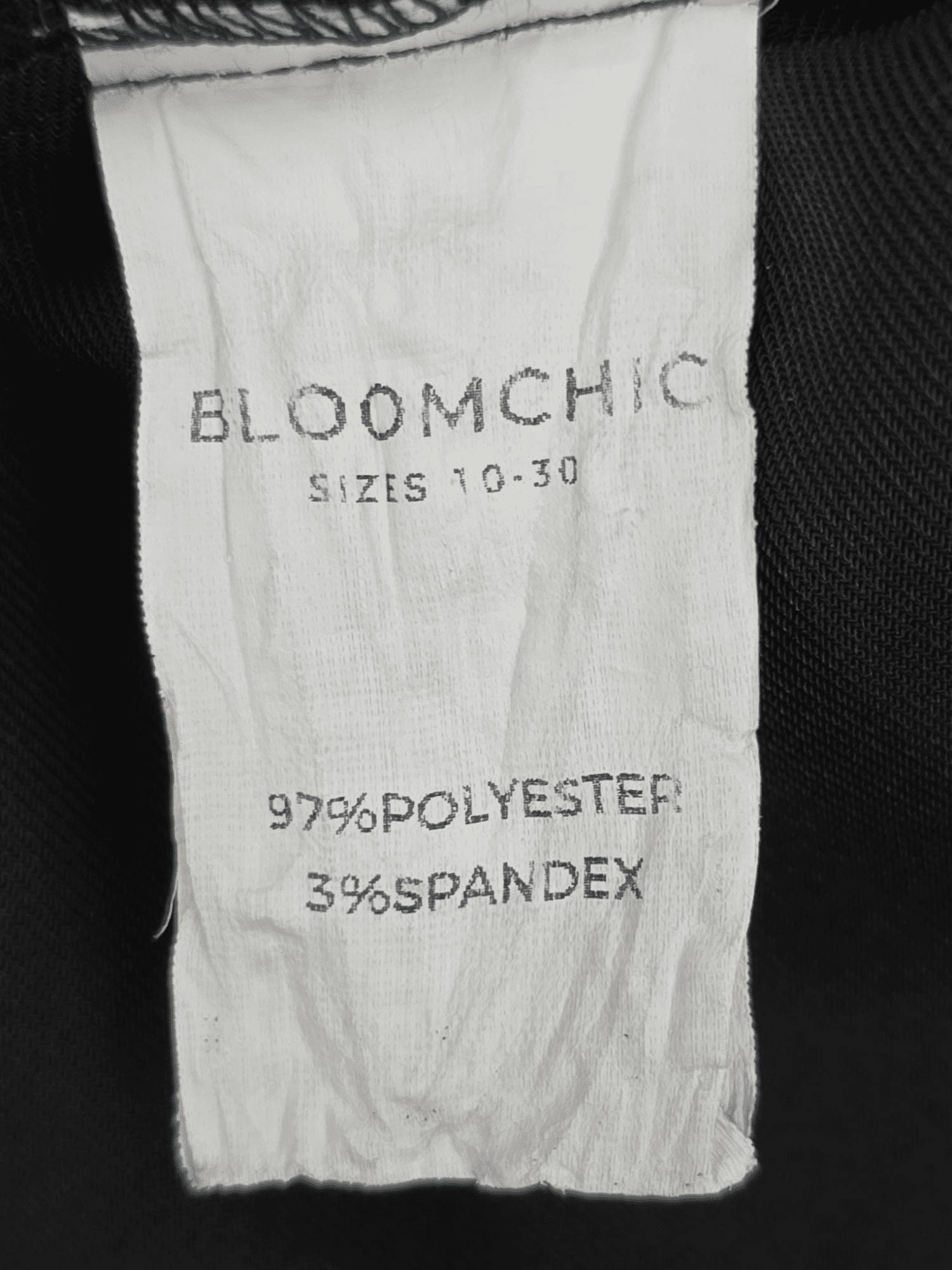 Bloom Chic black long sleeve cross-cut puff sleeve top material content label