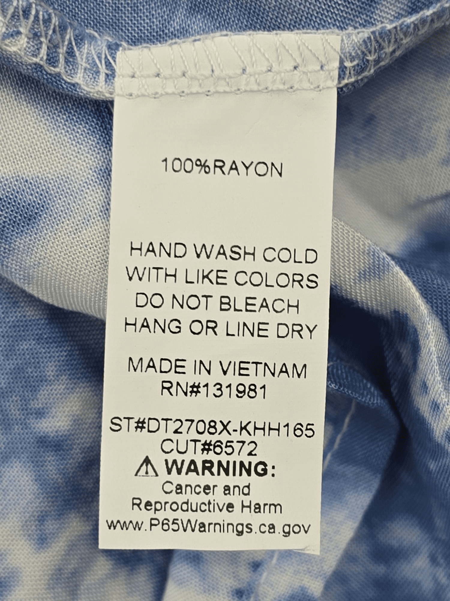 NAIF blue tie-dye on off-shoulder pullover top material content label