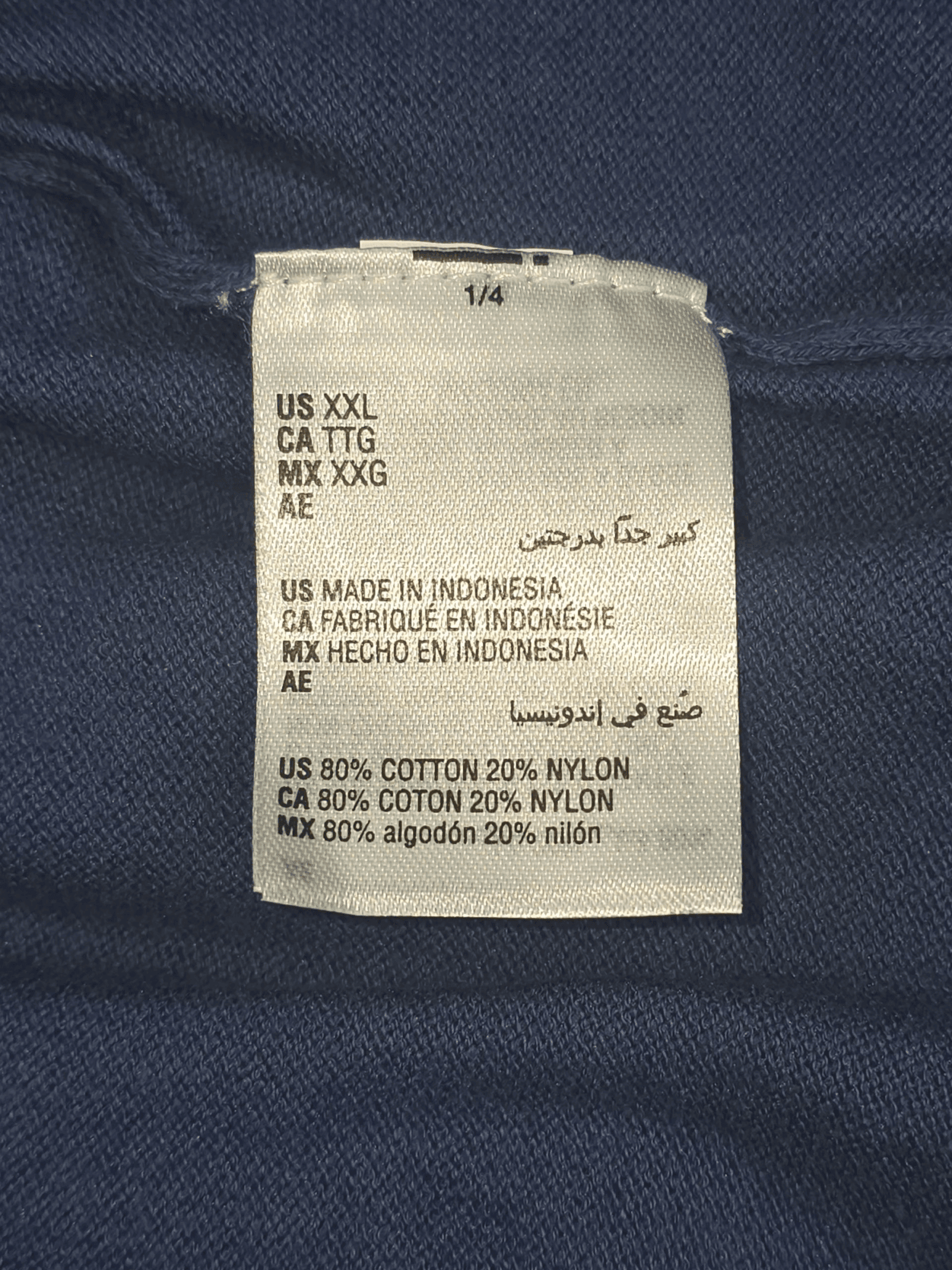 Close-up of material content and garment care tag on NWT ALFANI men’s size XXL navy blue cotton blend crew neck sweater