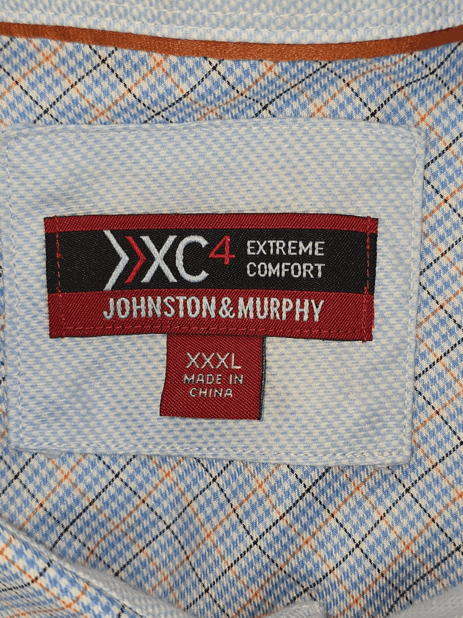 Close-up of Johnston & Murphy XC4 logo and size tag on 3XL cotton shirt