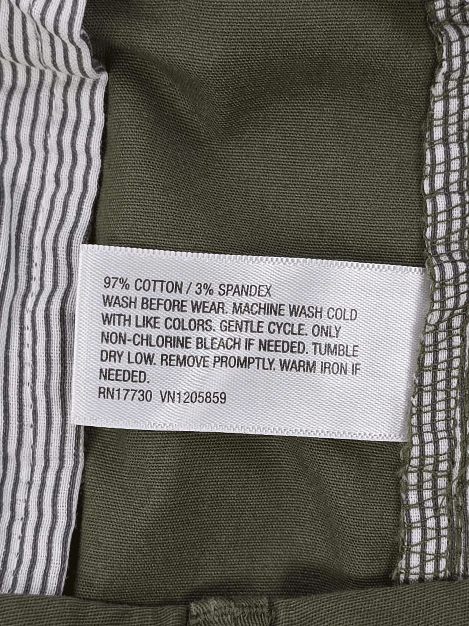 Close-up of material content and garment care tag on Goodfellow & Co men’s size 42 green Everywhere shorts