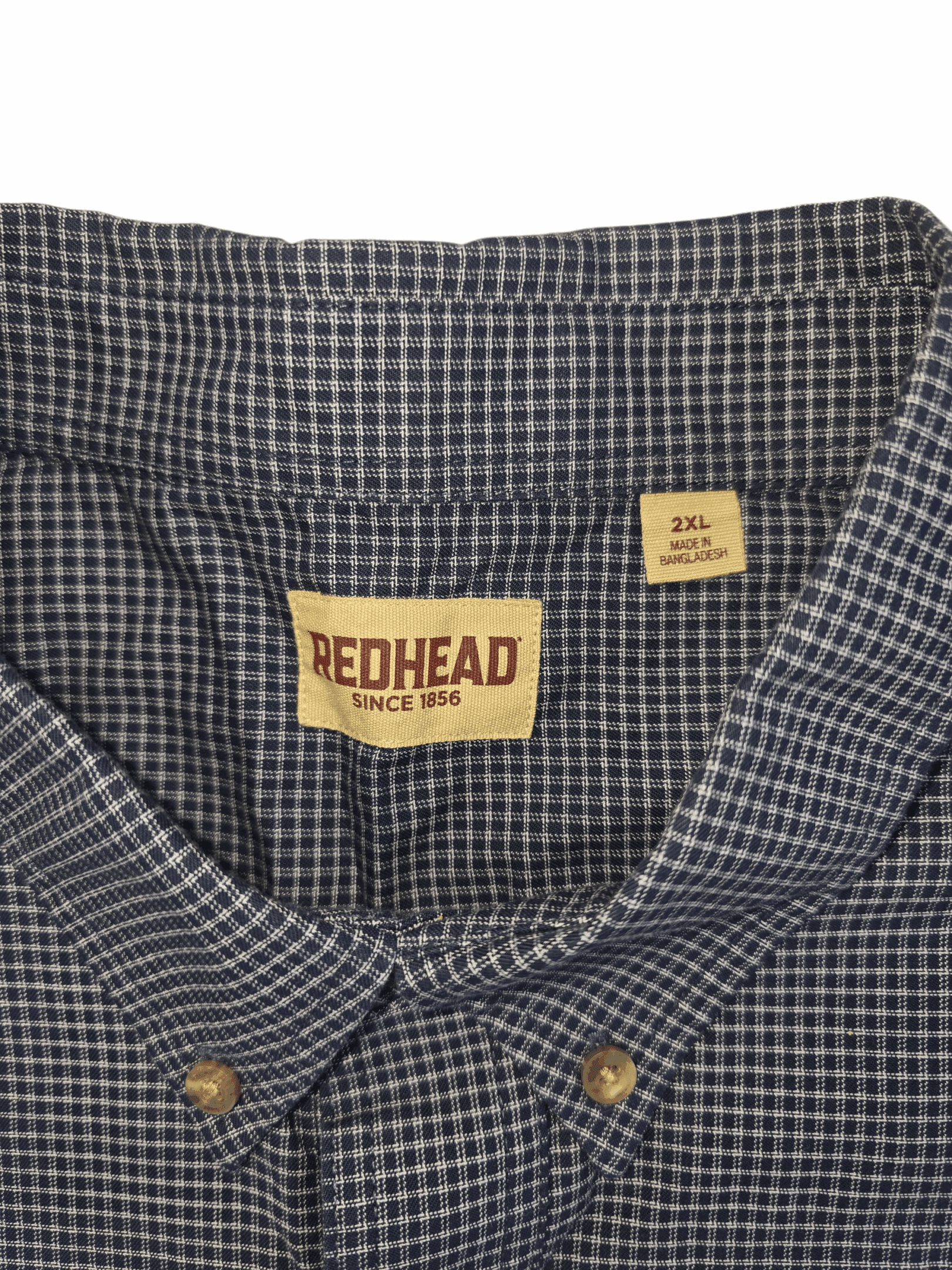 Close-up of RedHead brand and 2XL size tag on navy and white checked cotton button-up shirt