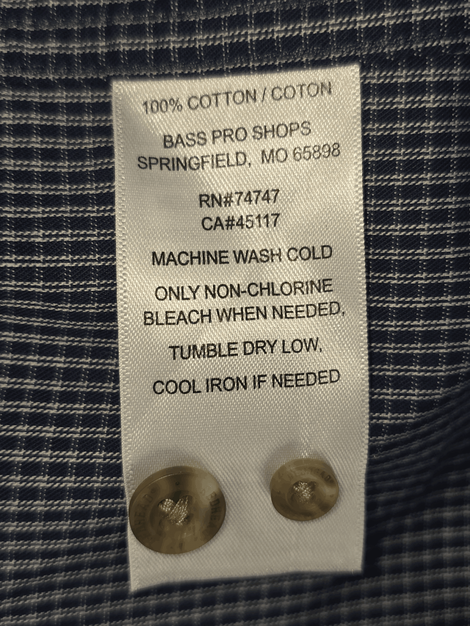 Close-up of material content and garment care tag on RedHead men’s size 2XL navy and white checked cotton button-up shirt