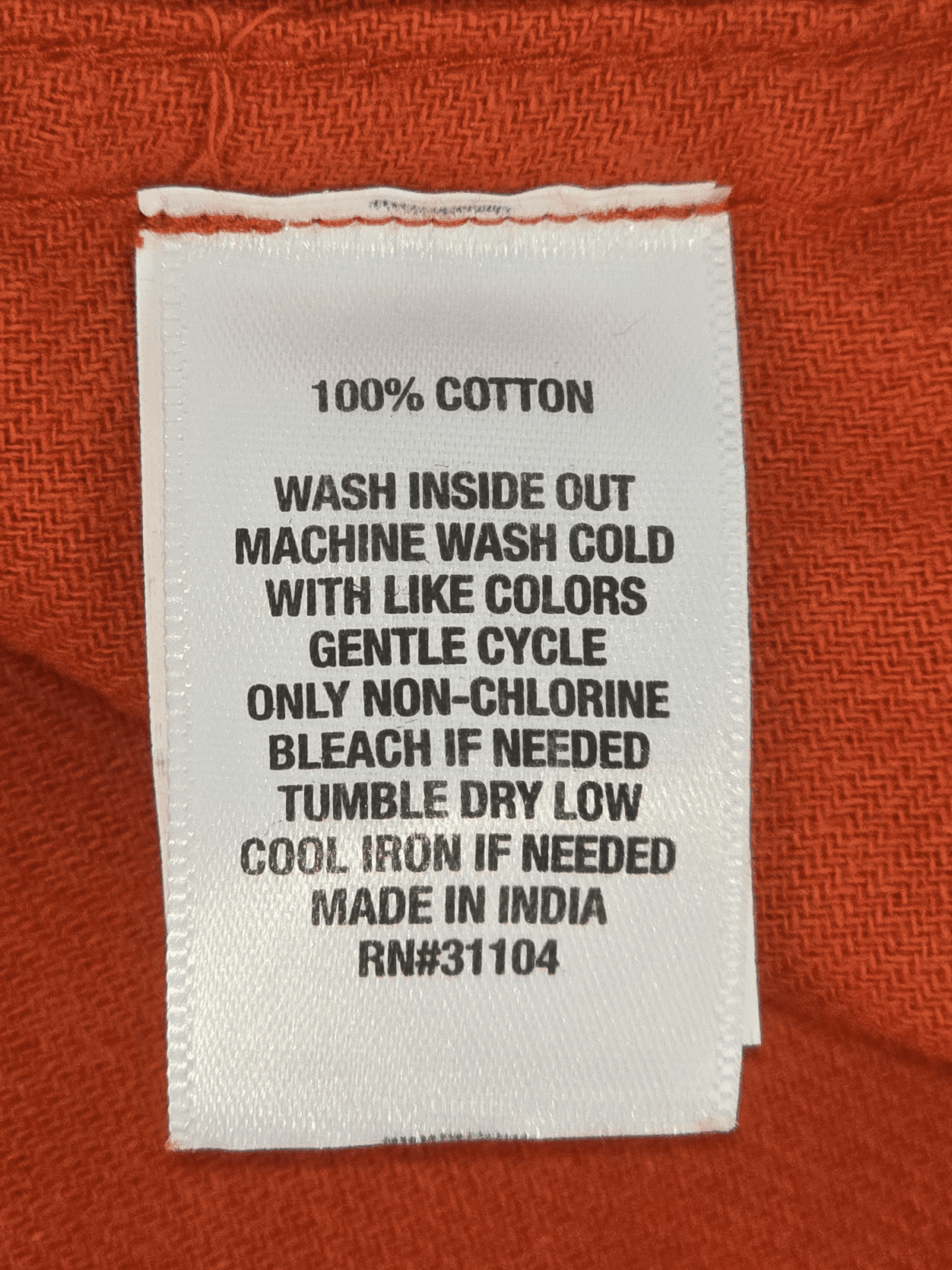 Close-up of material content and garment care tag on Ocean & Coast men’s 2XLT orange button-up shirt