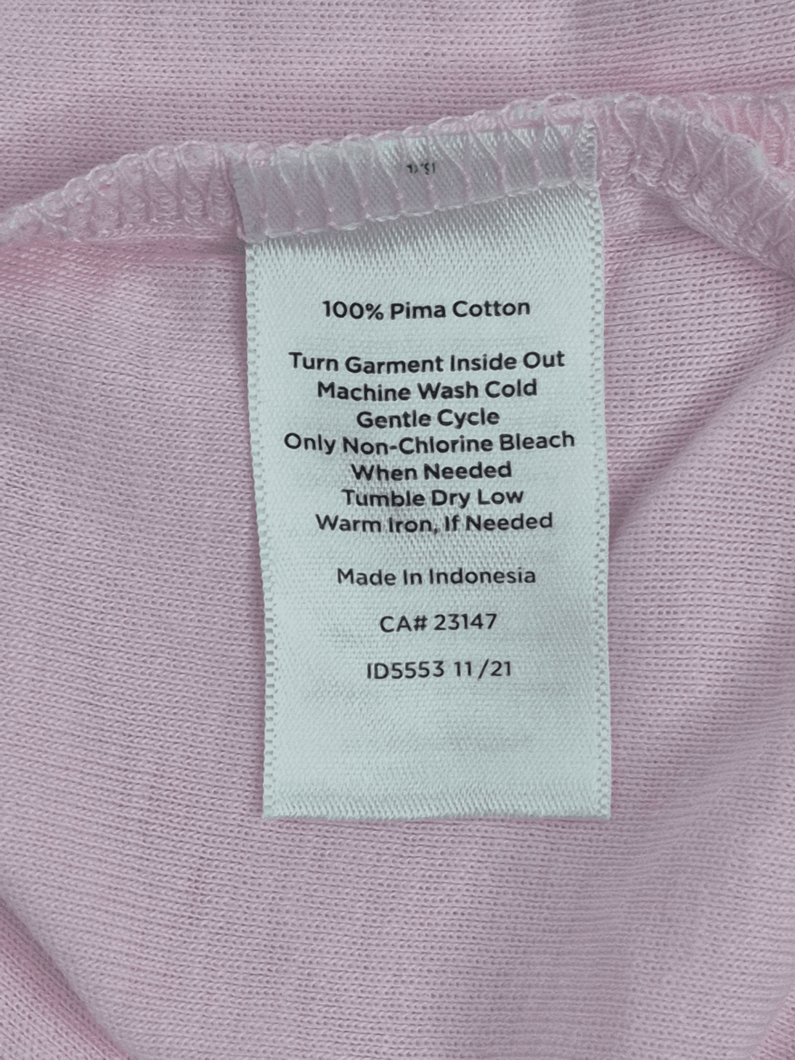 Close-up of material content and garment care tag on Talbots women’s size 3X medium pink Pima cotton split neck tee