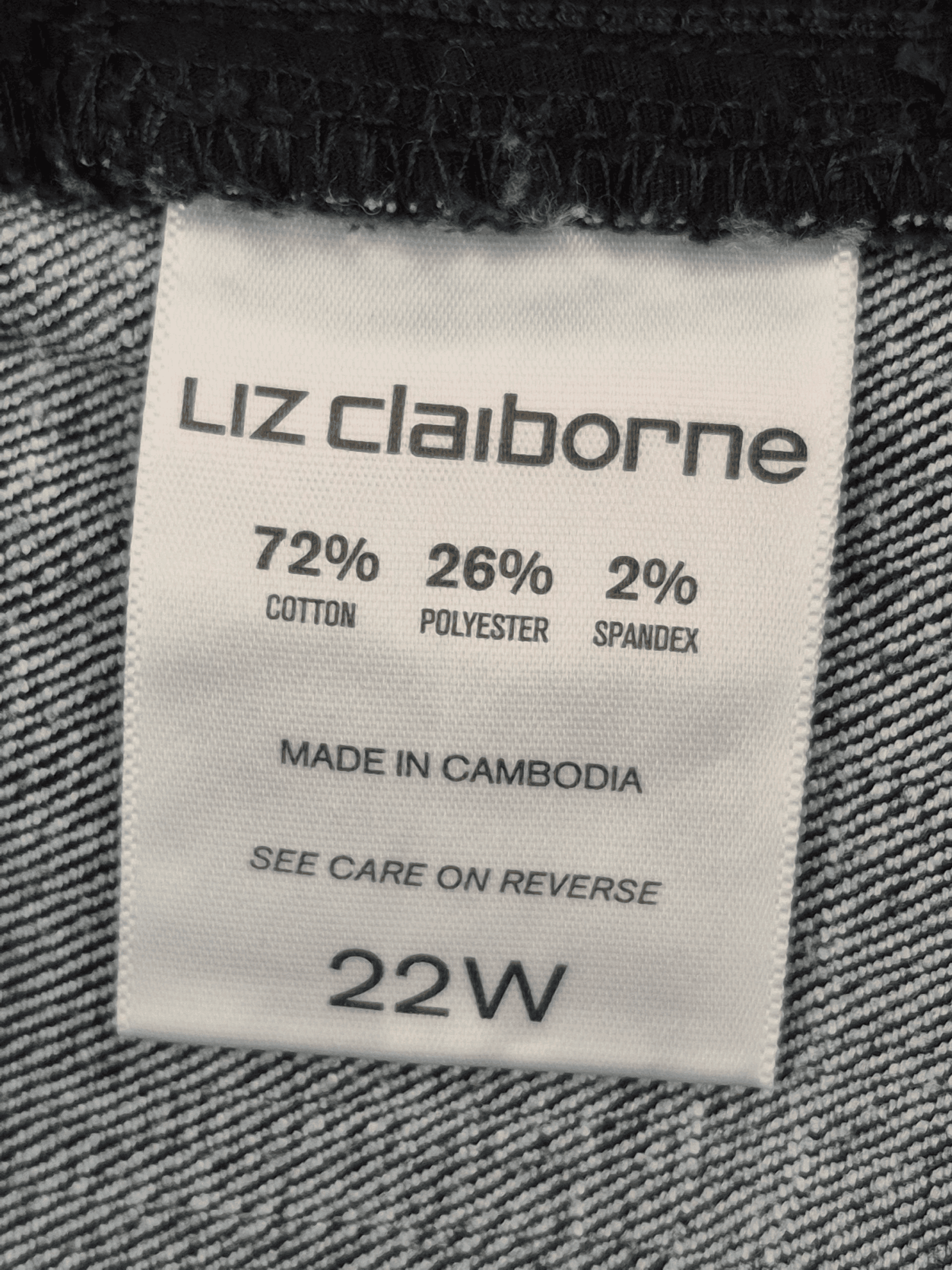 Close-up of material content and garment care tag on Liz Claiborne Woman size 22W Ultimate Fit dark wash jeans