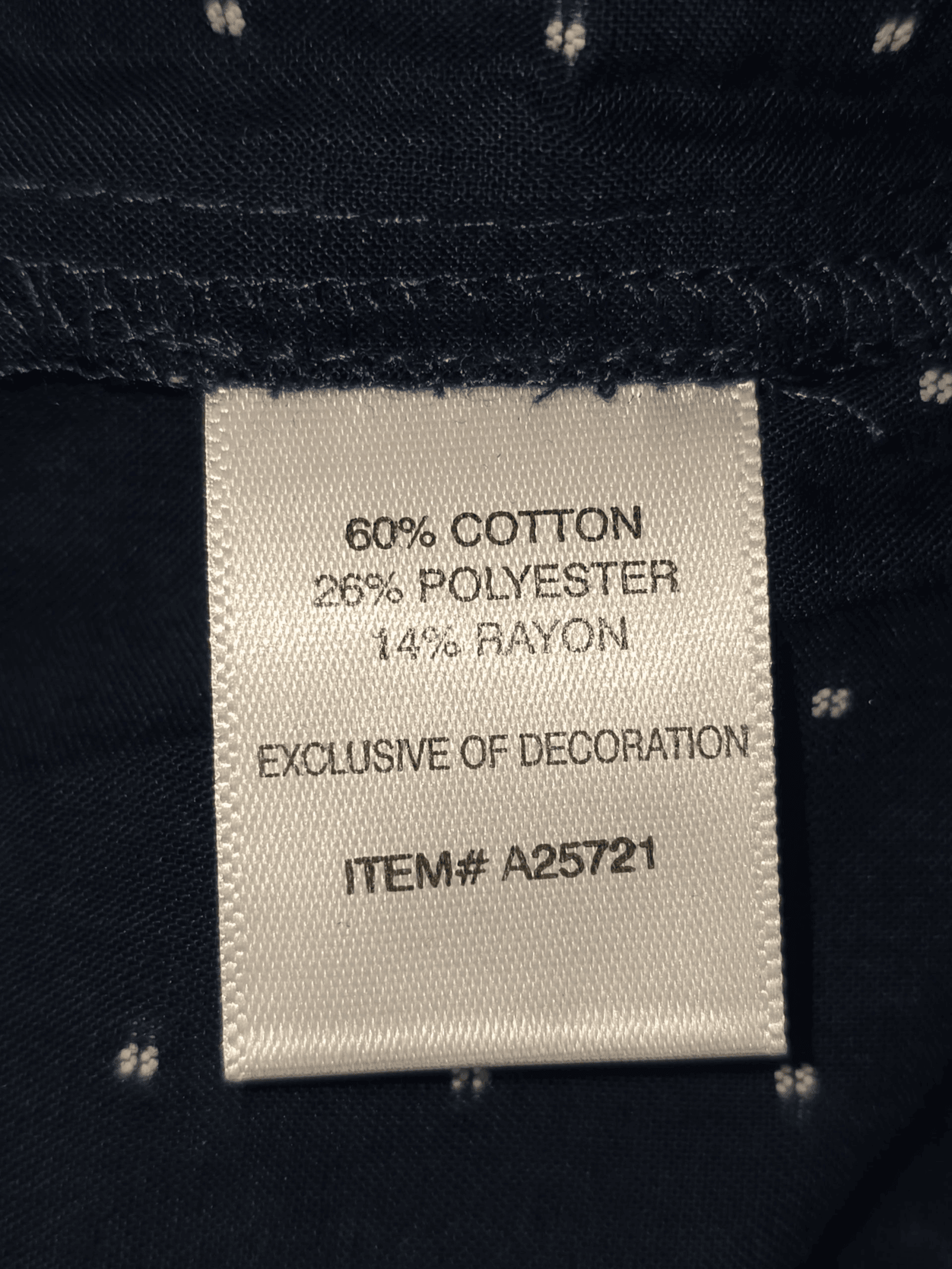 Close-up of material content and garment care tag on Appleseed’s women’s 3X navy blue clip dot button-front top