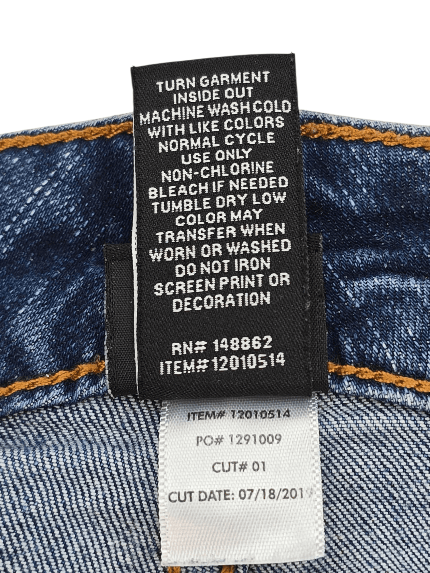 Close-up of material content and garment care tag on Disney women’s size 20 blue denim cropped jeans with Mickey Mouse patchwork