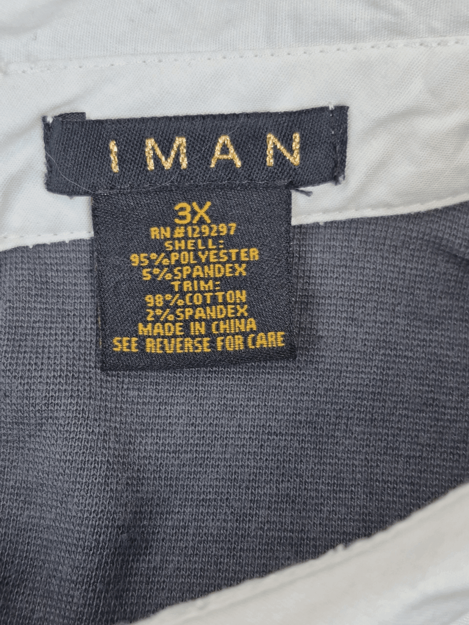 Close-up of IMAN brand and 3X size tag on gray knit pullover faux layered top