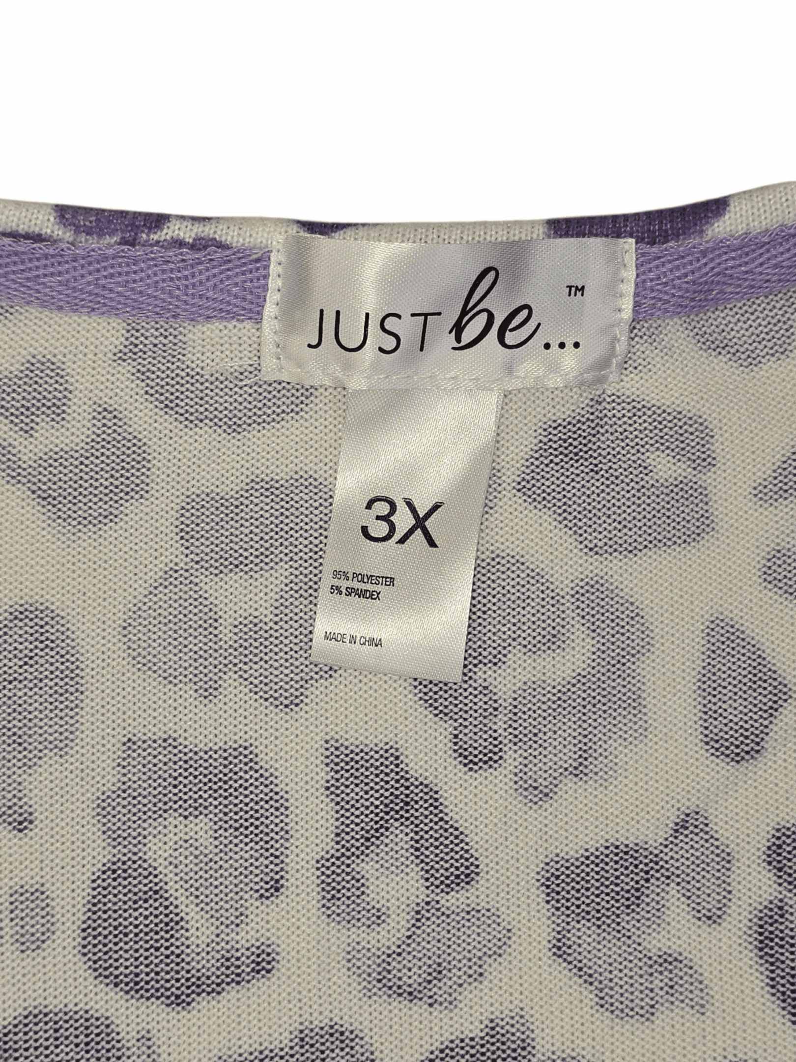 Close-up of Just Be brand and 3X size tag on purple and white animal print sweater