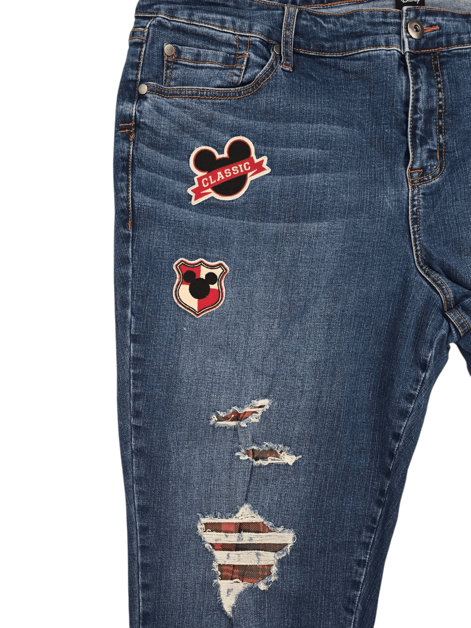 Close-up of Mickey Mouse patchwork on Disney women’s size 20 blue denim cropped jeans