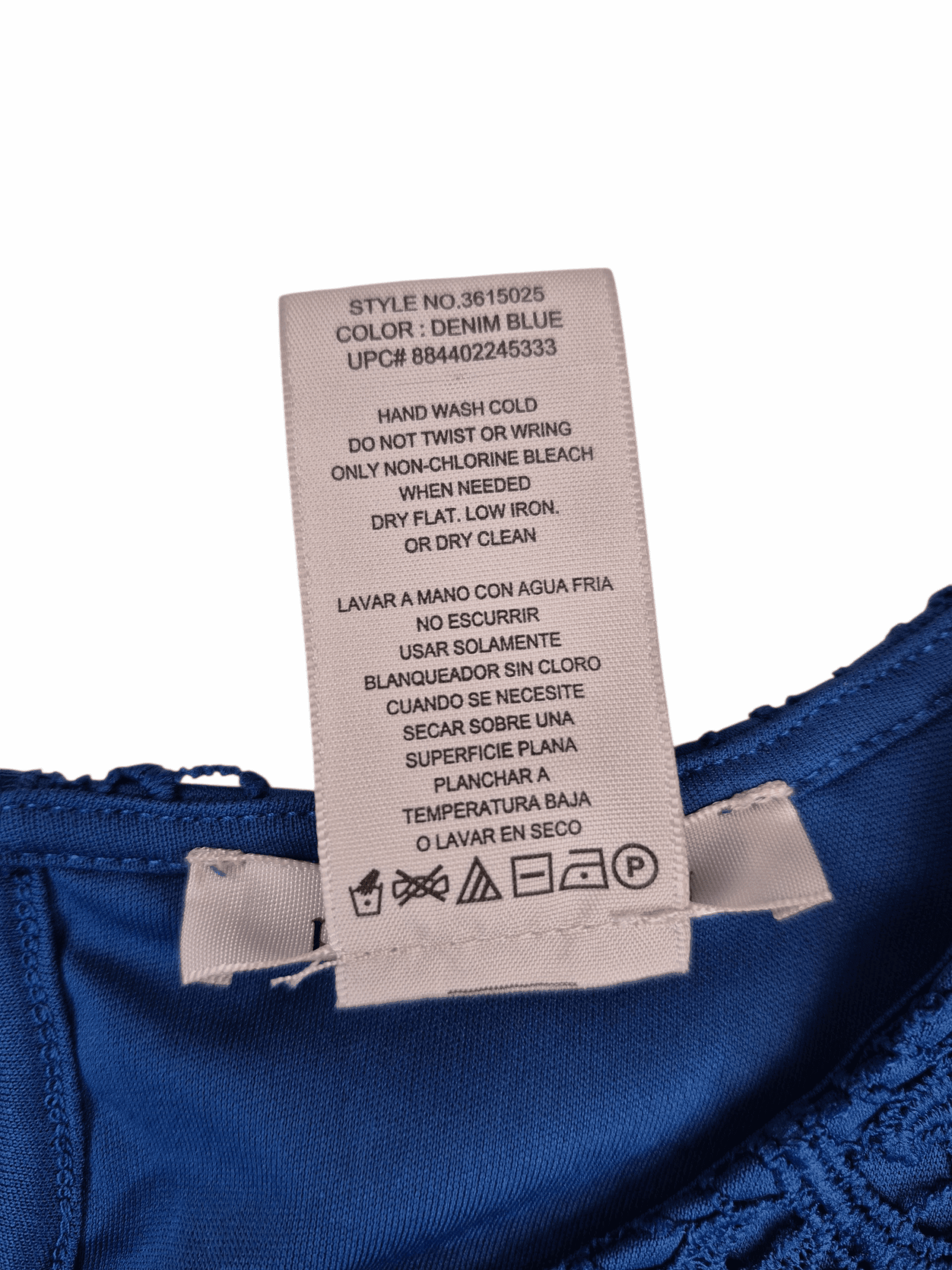 Close-up of material content and garment care tag on Philosophy Republic Clothing women’s size 2X blue lace overlay top