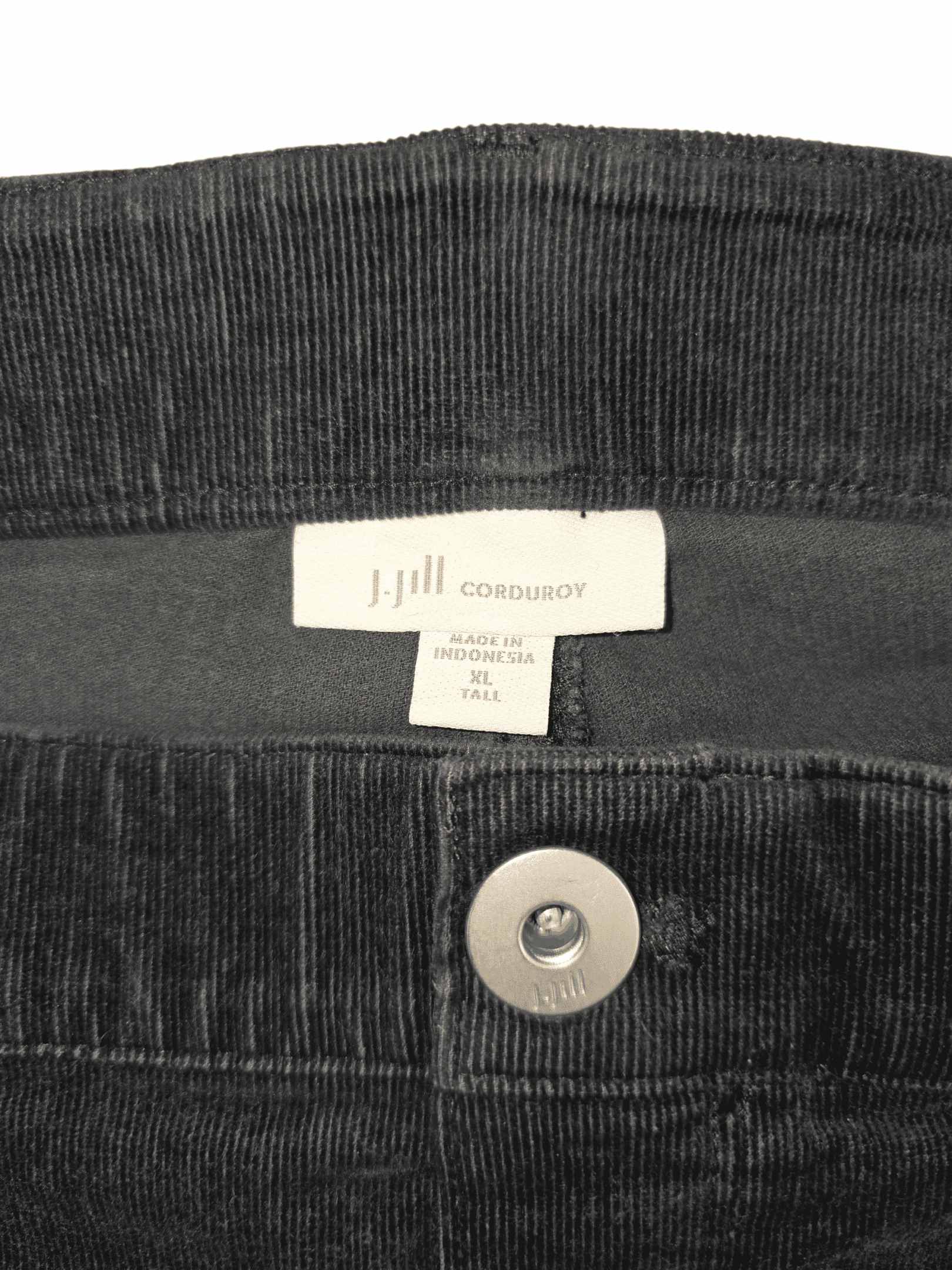 Close-up of J. Jill brand and XLT size tag on smoky gray corduroy straight-leg pants