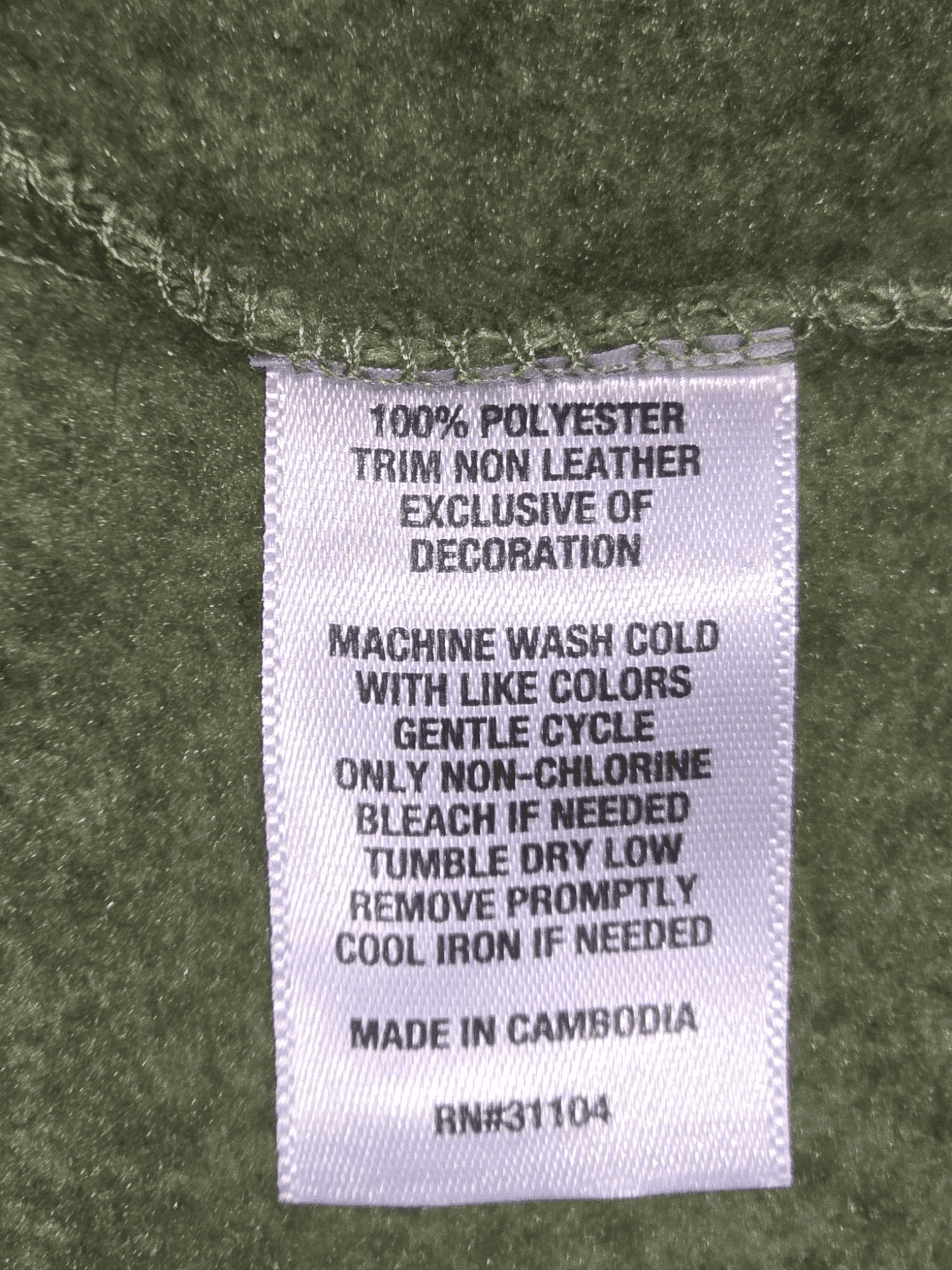 Close-up of Crown & Ivy brand and XXL size tag on green full-zip winter vest