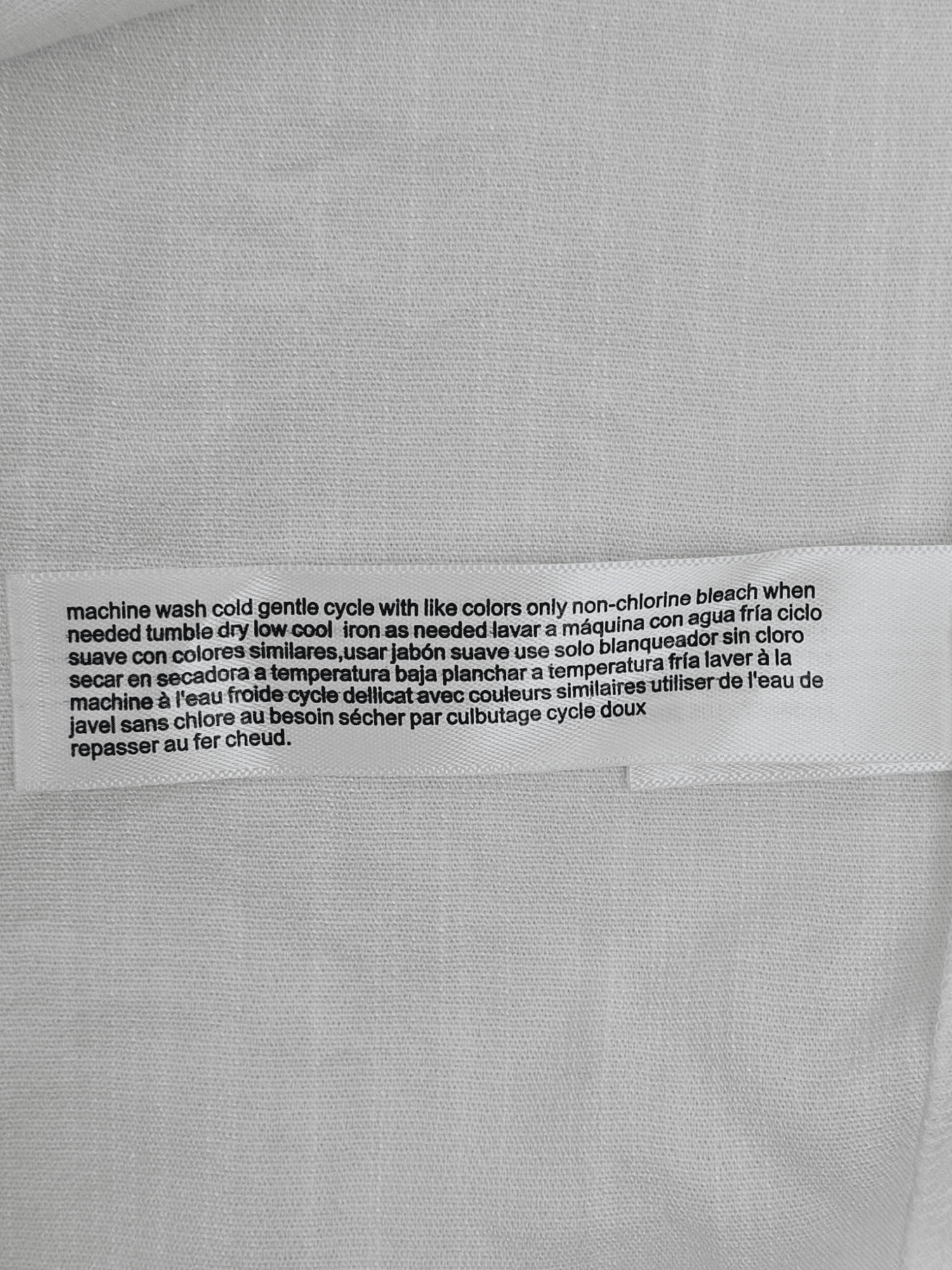 ELOQUII white sleeveless V-neck button-up blouse care instructions tag