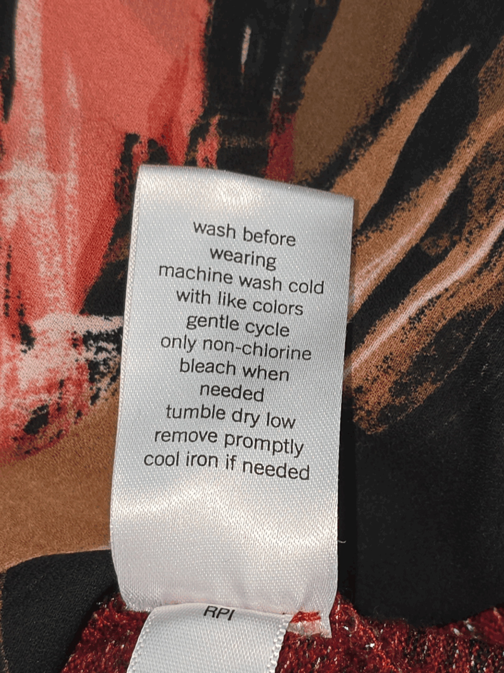 EVRI red and black layered-look pullover sweater care instructions label