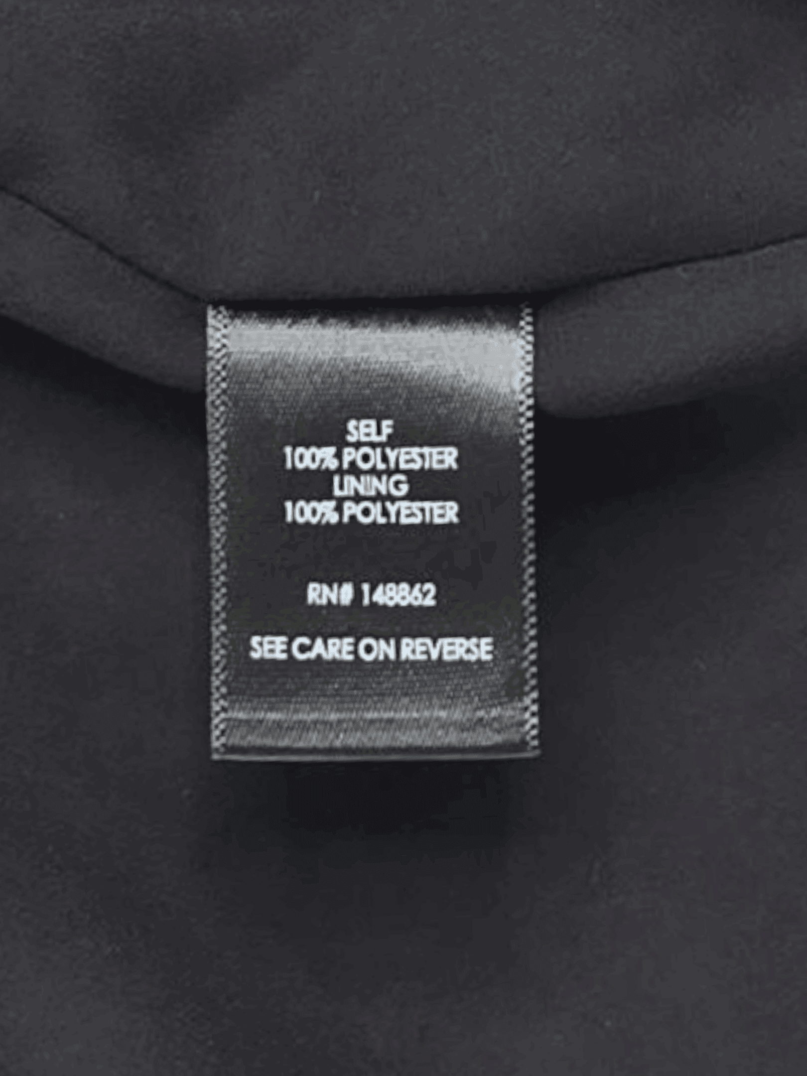 Close-up of material content and garment care tag on Torrid women’s plus size 4X Sophie floral cami top