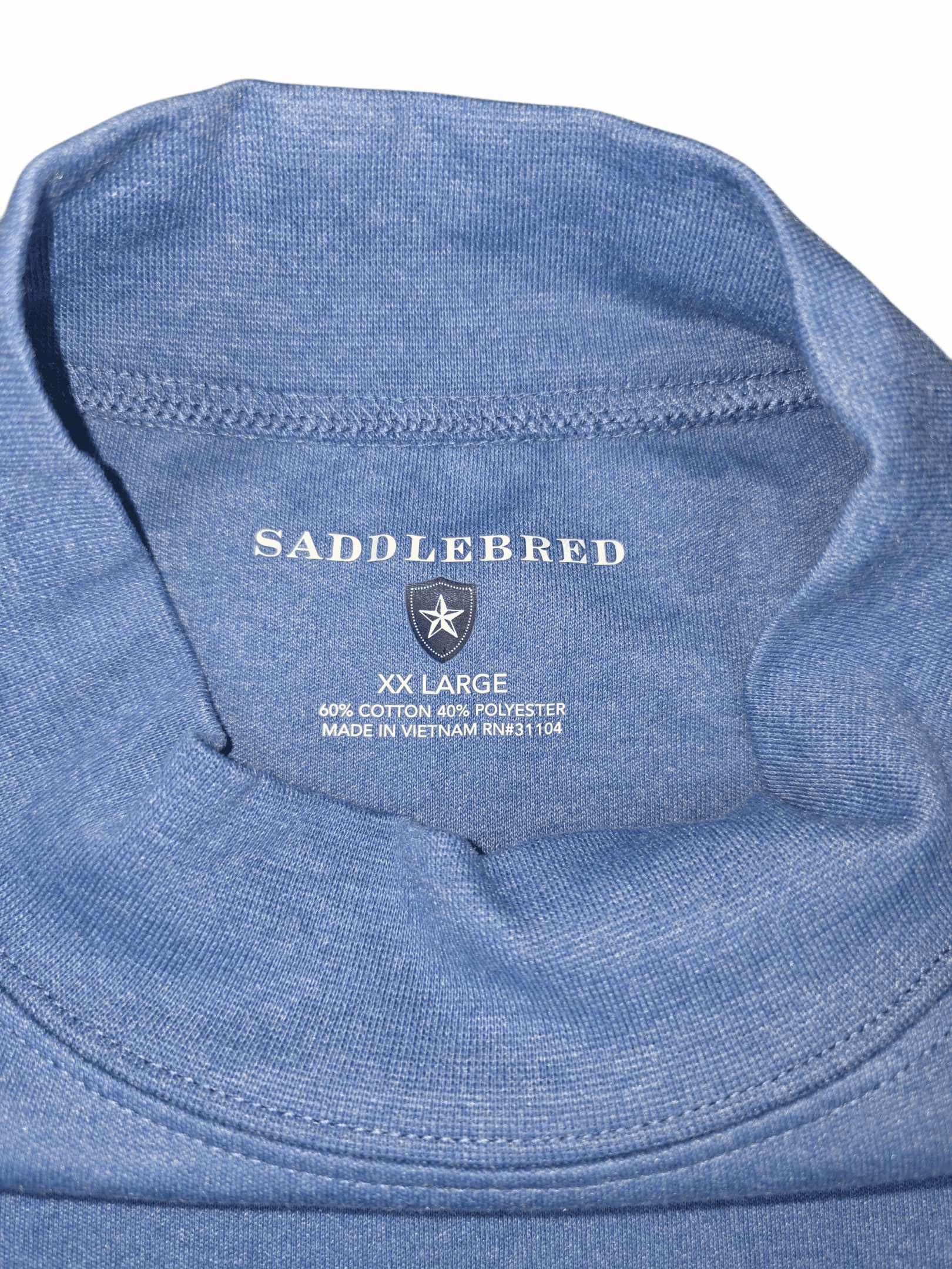 Close-up of Saddlebred brand and XXL size tag on blue mock neck pullover