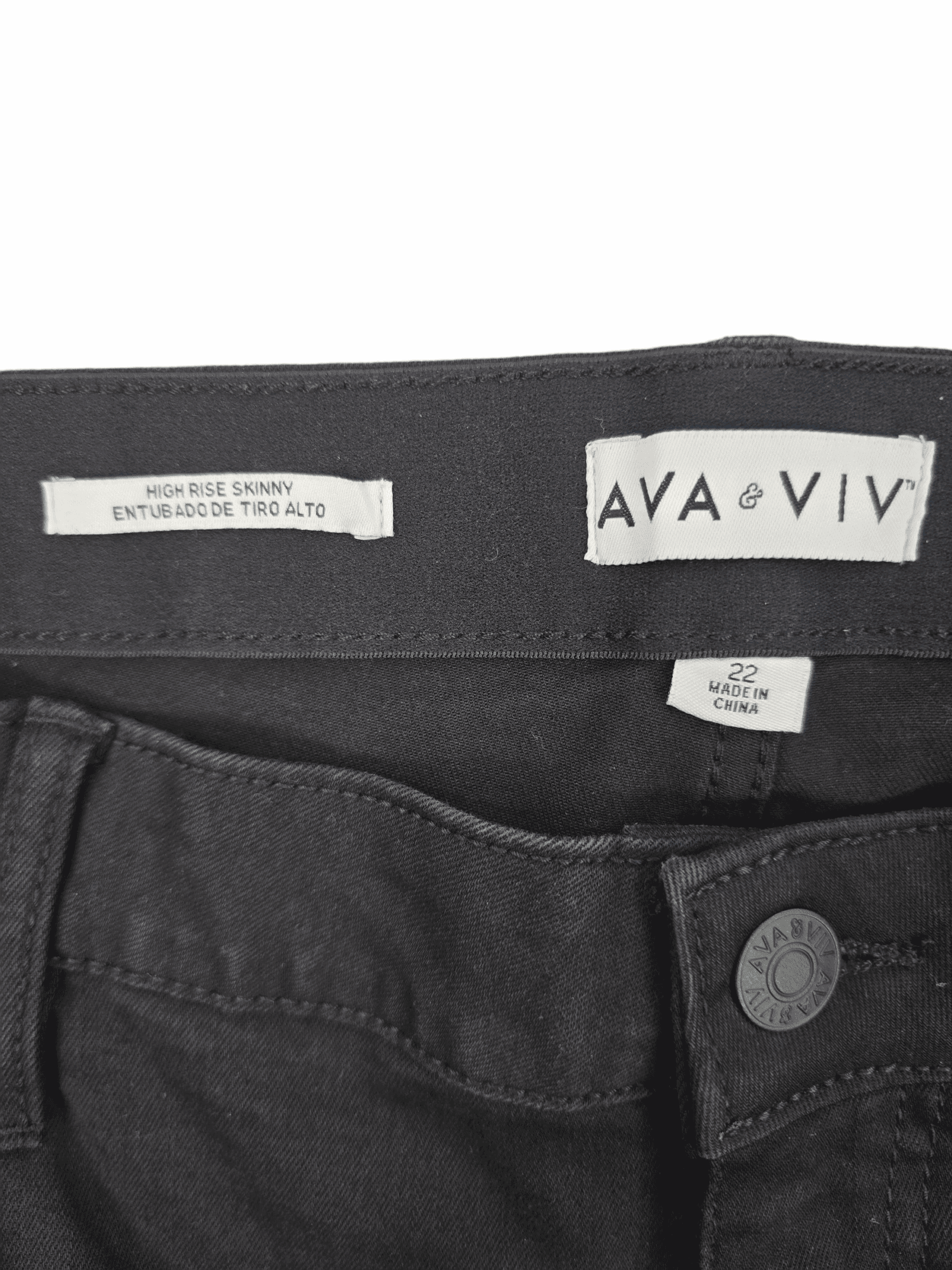 Close-up of Ava & Viv brand and size 22 tag on black high-rise skinny jeans