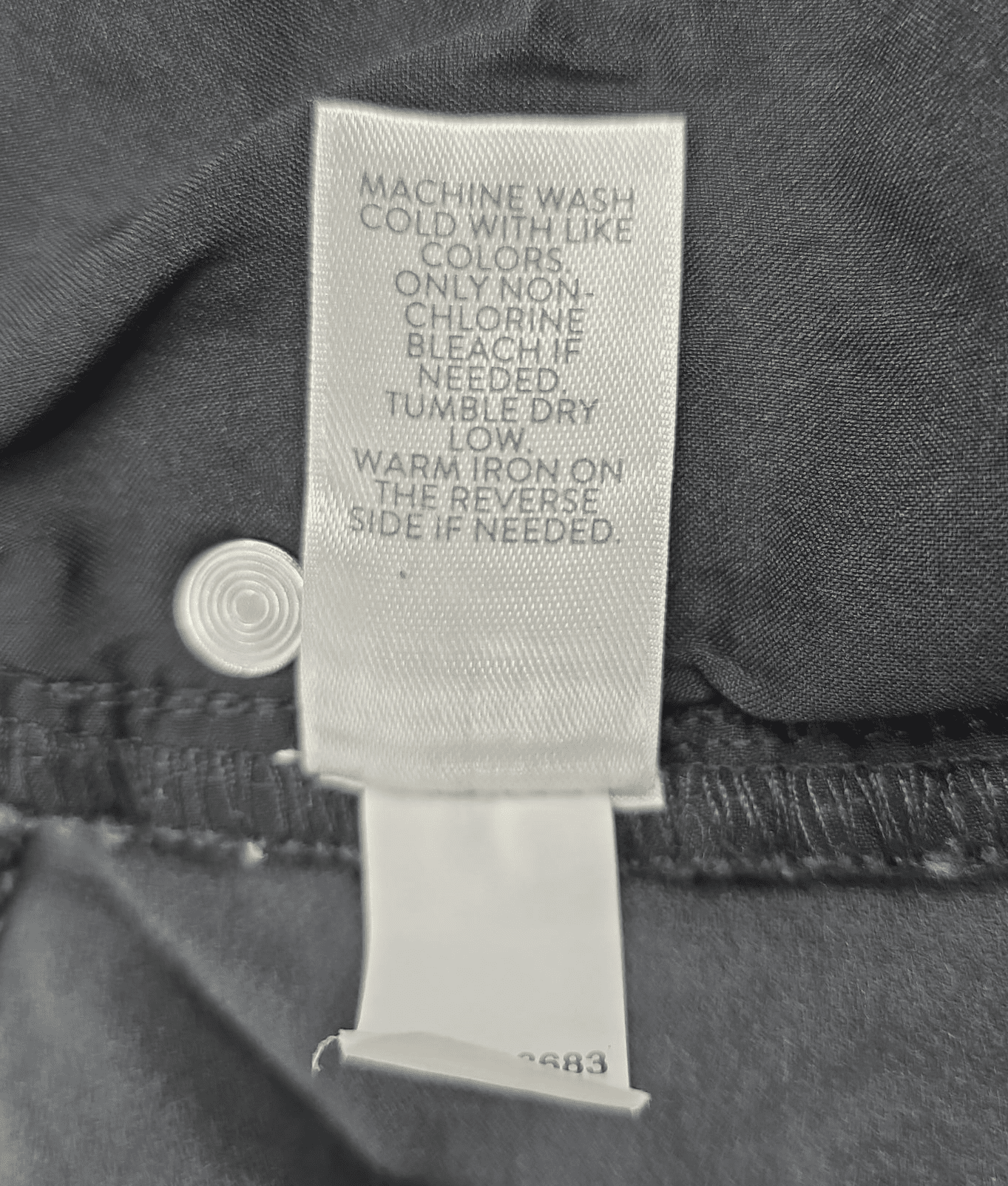 Close-up of J. Jill brand and XLT size tag on smoky gray corduroy straight-leg pants
