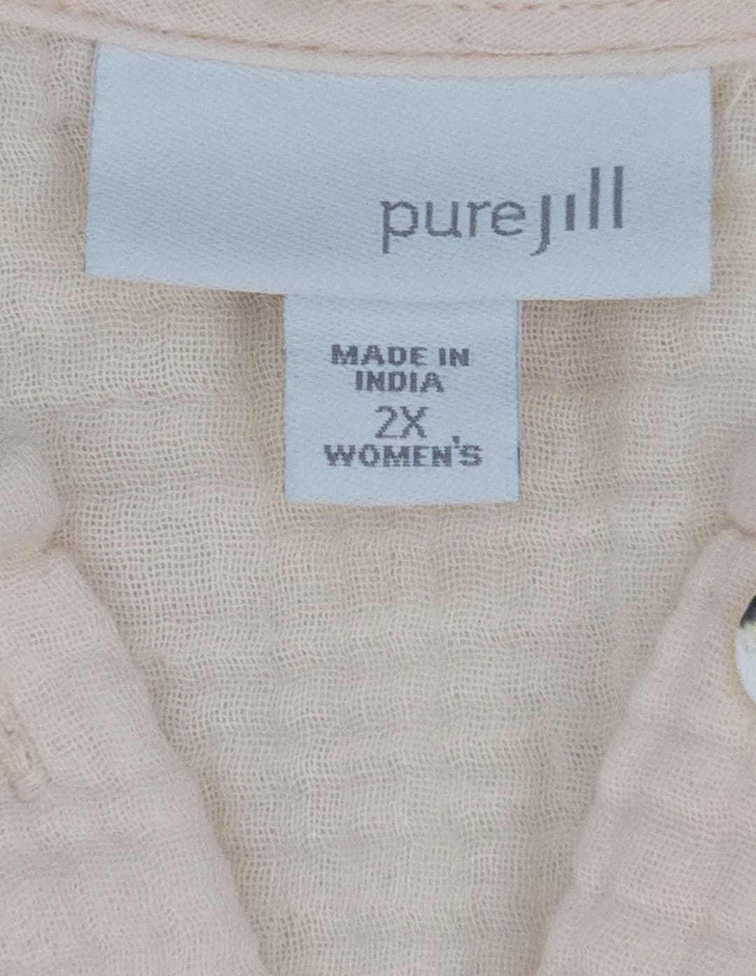 Close-up of Pure Jill brand and 2X size tag on soft pink cotton top
