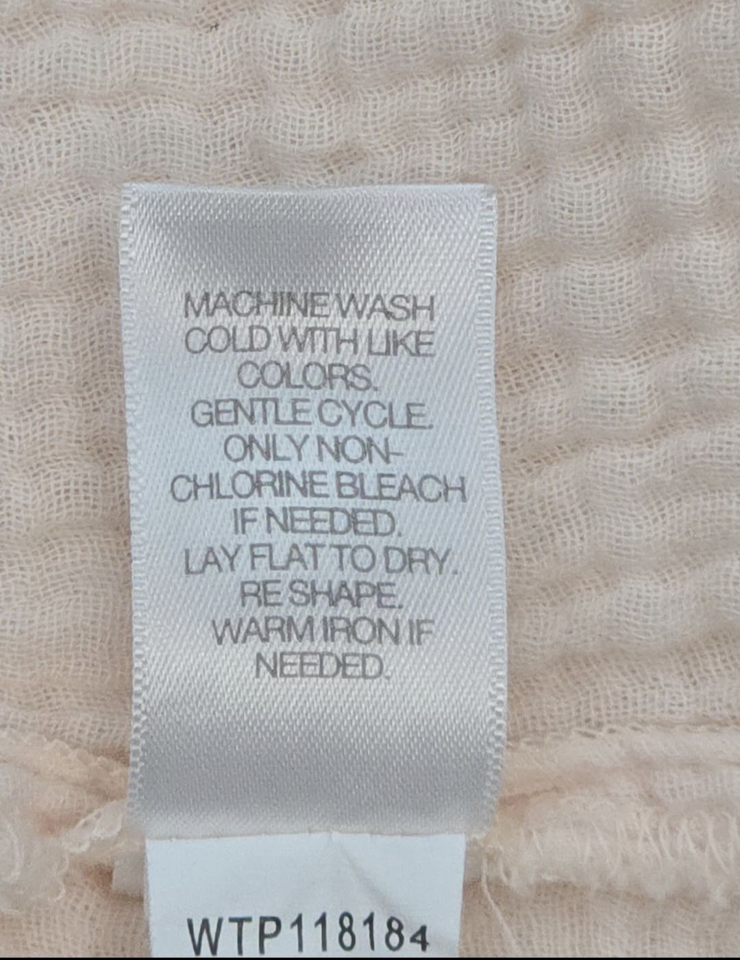 Close-up of material content and garment care tag on Pure Jill women’s size 2X soft pink cotton top