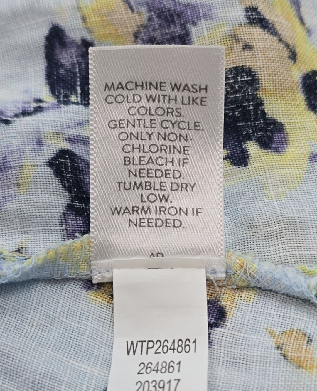 Close-up of material content and garment care tag on J. Jill Love Linen women’s size 2X floral button-up top