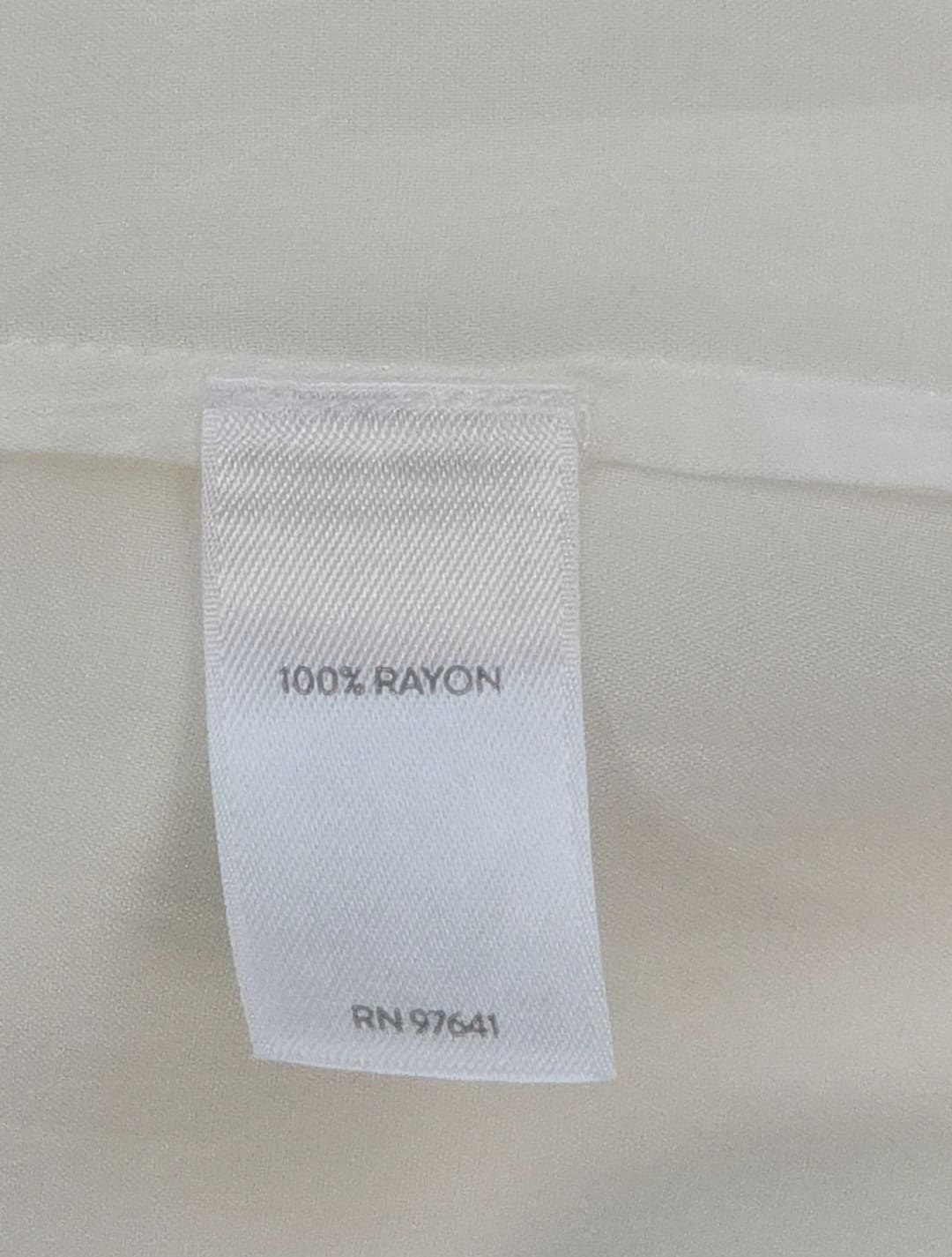 Close-up of material content and garment care tag on J. Jill women’s size 2X ivory embroidered rayon top