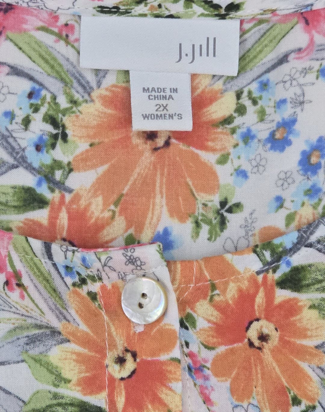 Close-up of J. Jill brand and 2X size tag on floral rayon button-front top