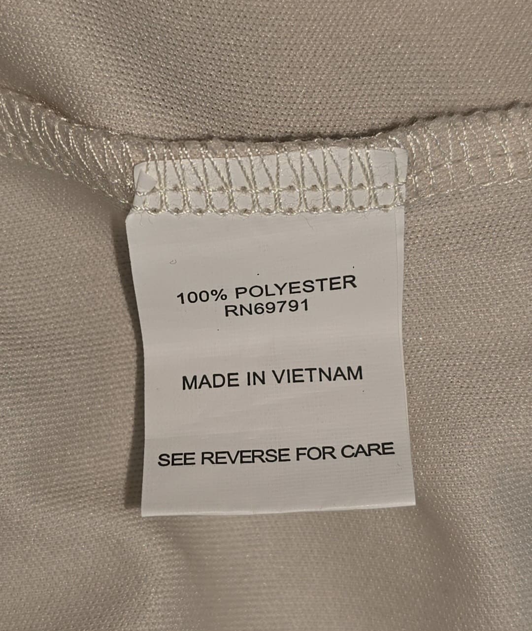 Close-up of material content and garment care tag on Sarah Michelle Woman women’s size 1X floral chiffon pullover top