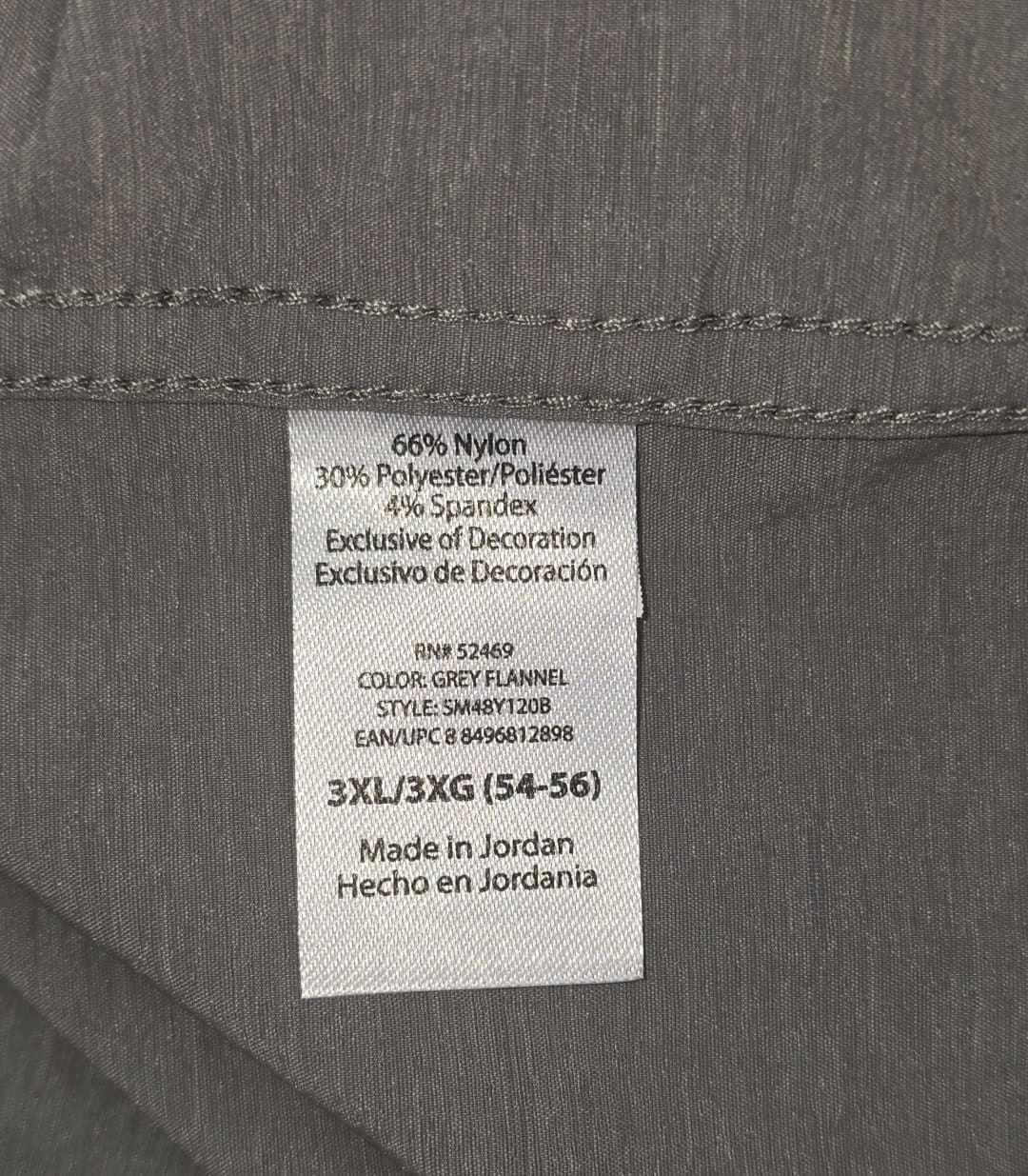 Close-up of material content and garment care tag on Swiss Tech men’s size 3XL gray long sleeve button-up shirt