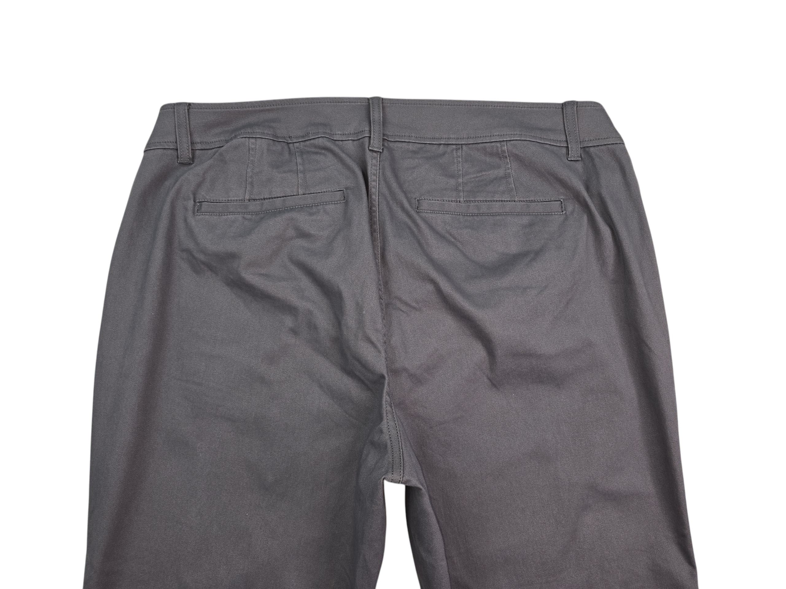 Back view of black leather pants with visible seams and pockets.