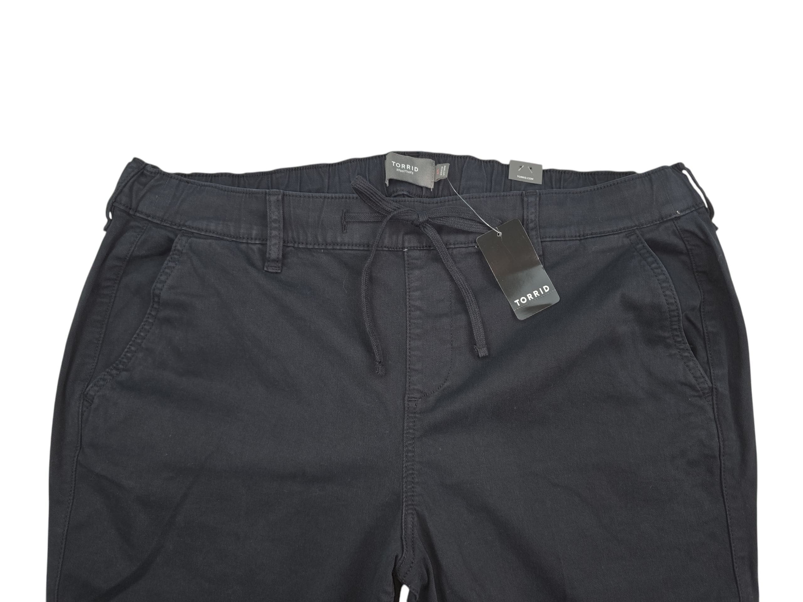 Black pants with tags attached, laid flat.