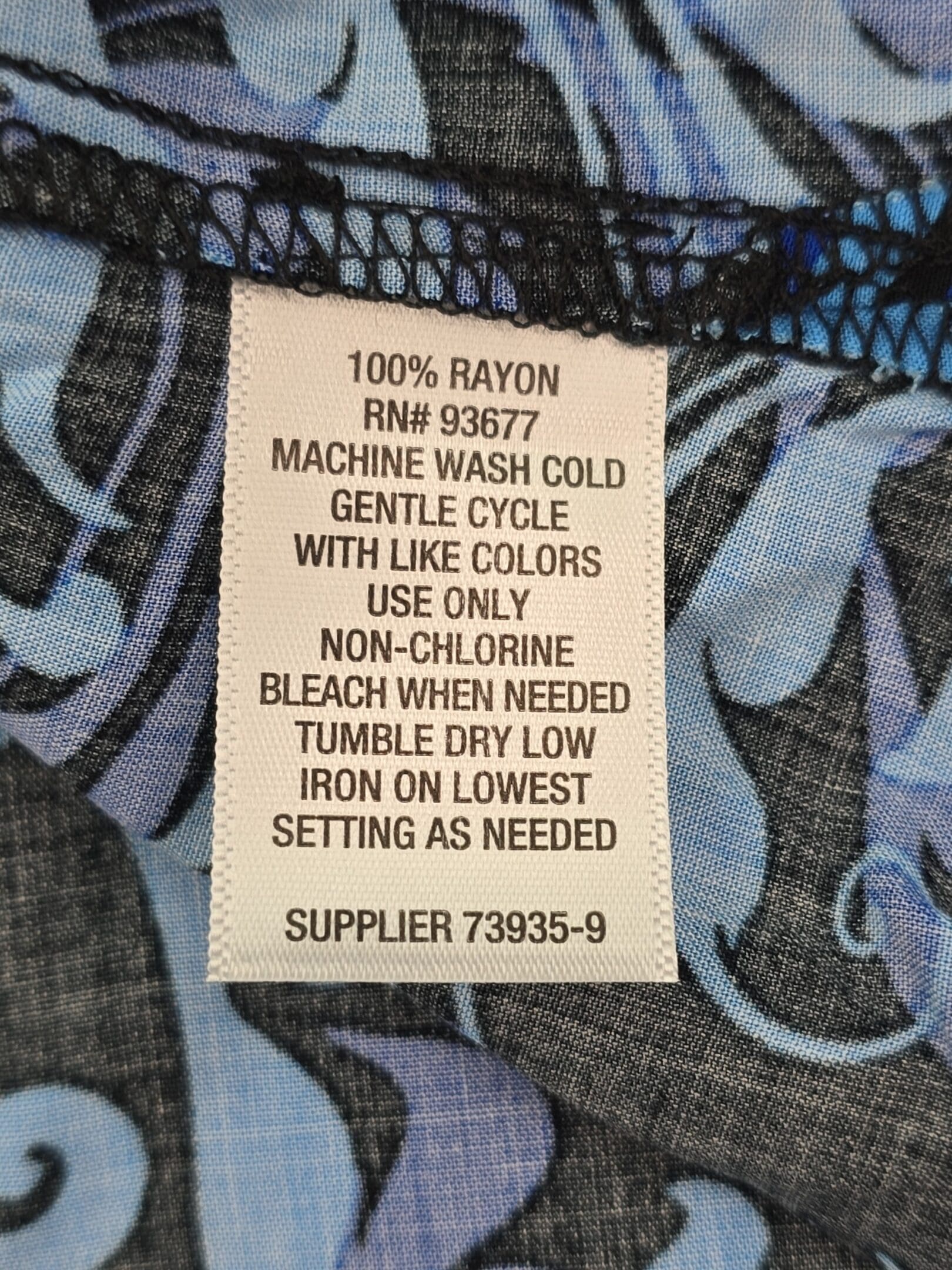Material tag of Liz Claiborne women’s blouse showing 100% rayon